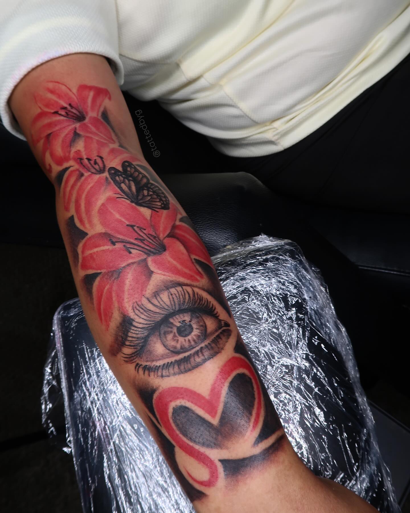 Eye and flowers realism tattoo on the forearm by ✧ Dallas Tattoo Artist  ✧