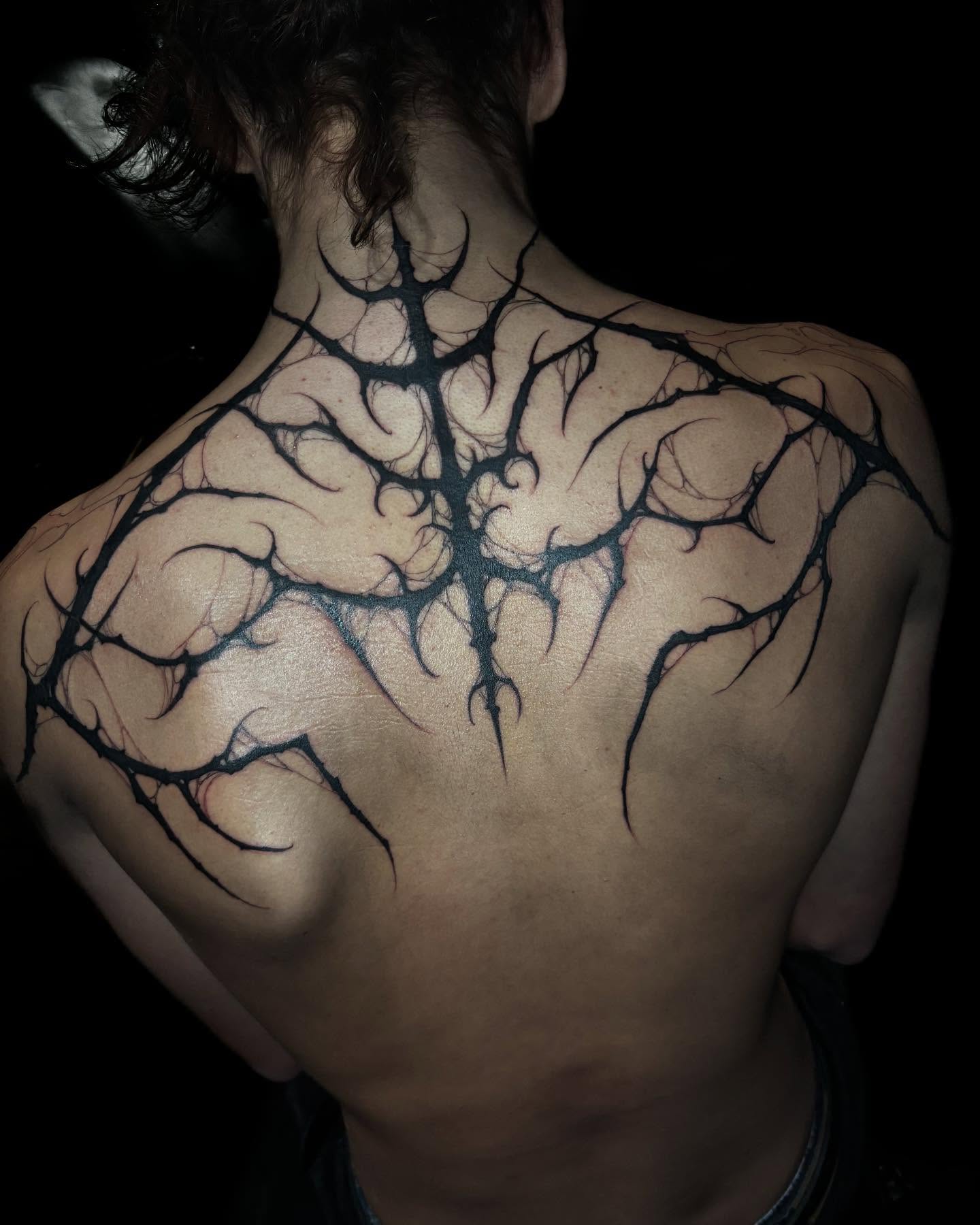 Spine tattoo black and grey tattoo on the back by Sofia Rose