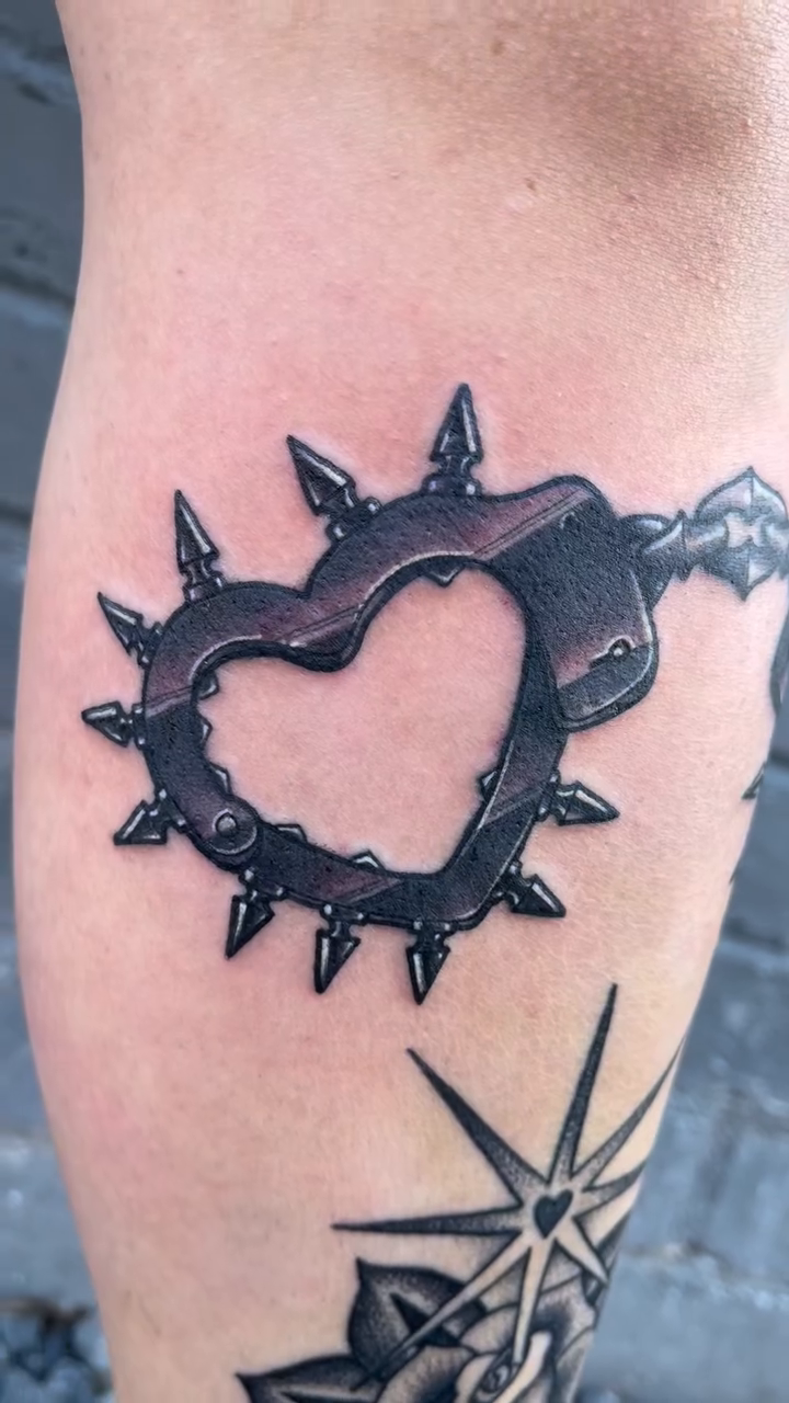 Heart-shaped handcuffs and rose realism tattoo by Chris Sparks, I just go by Sparks.