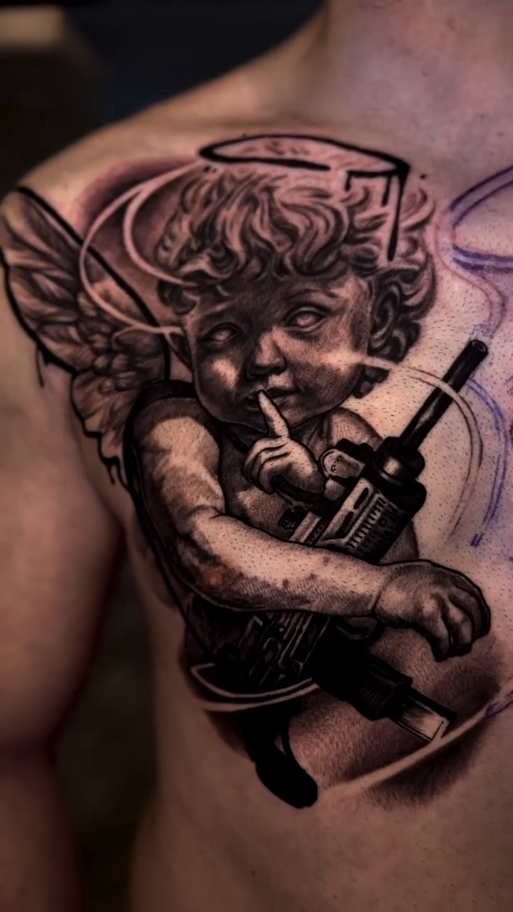 Cherub with a gun realism tattoo by Tony Ink