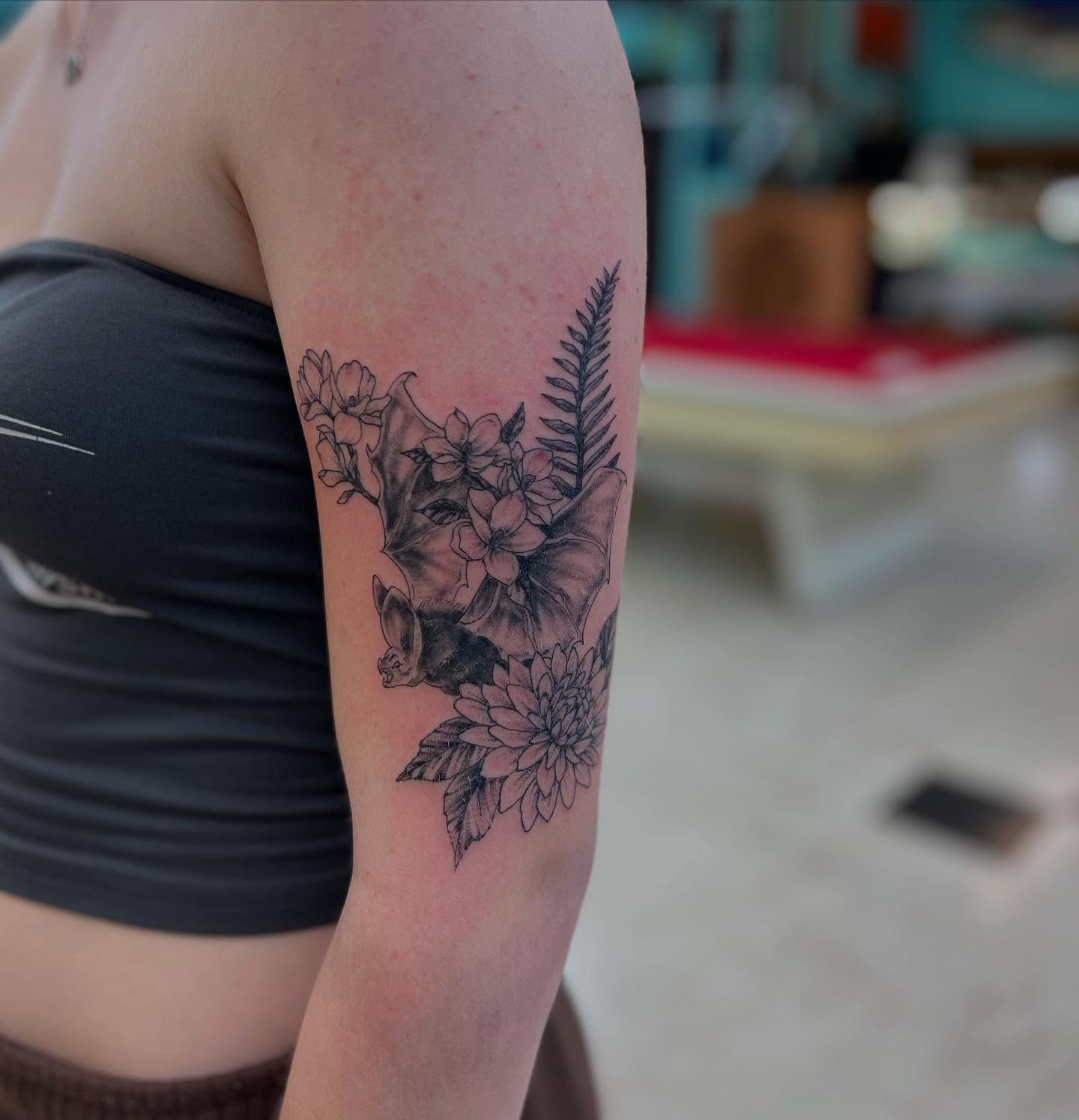 Floral arrangement black and grey tattoo on the forearm by Levi Sawdon, Everett, Washington