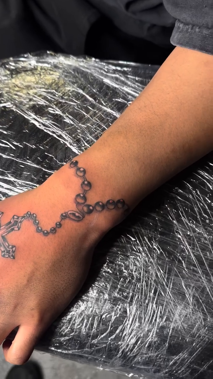 Rosary beads and cross Chicano tattoo by Sincere