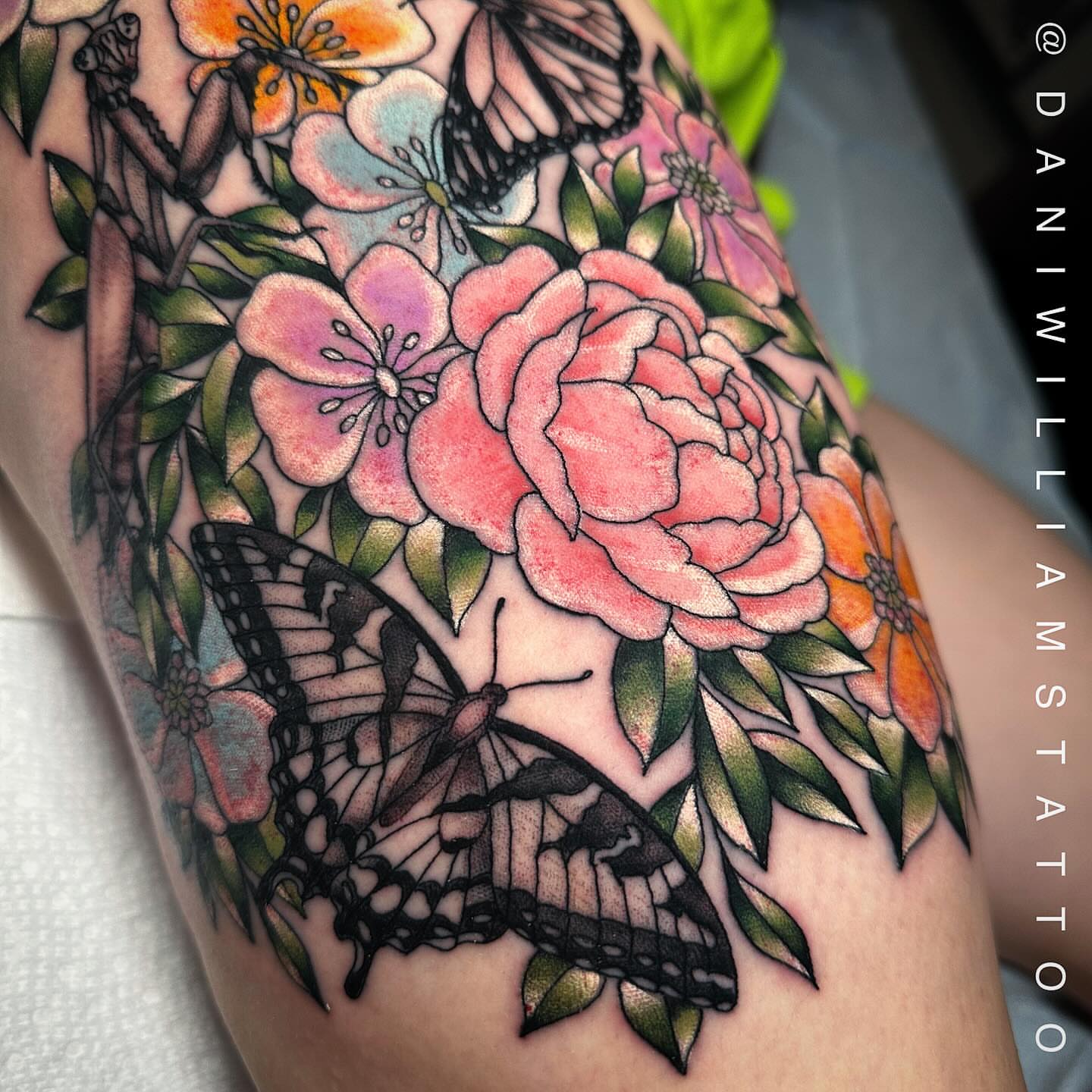 Flowers and butterflies realism tattoo on the thigh by Dani Johnson