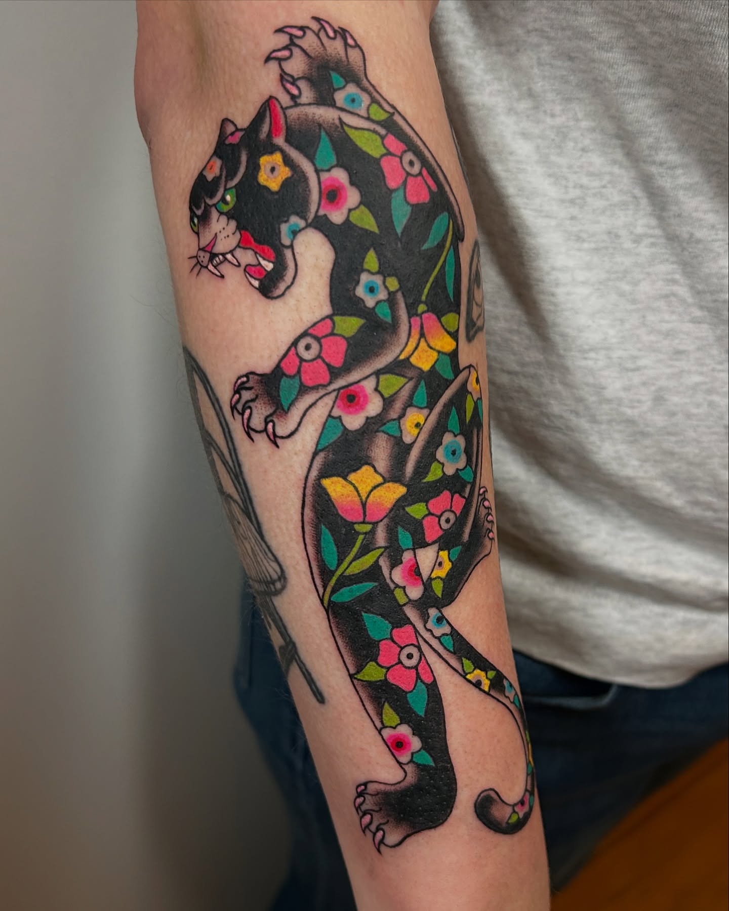Panther with floral patterns American traditional tattoo on the forearm by ☻ darby robertson ☻