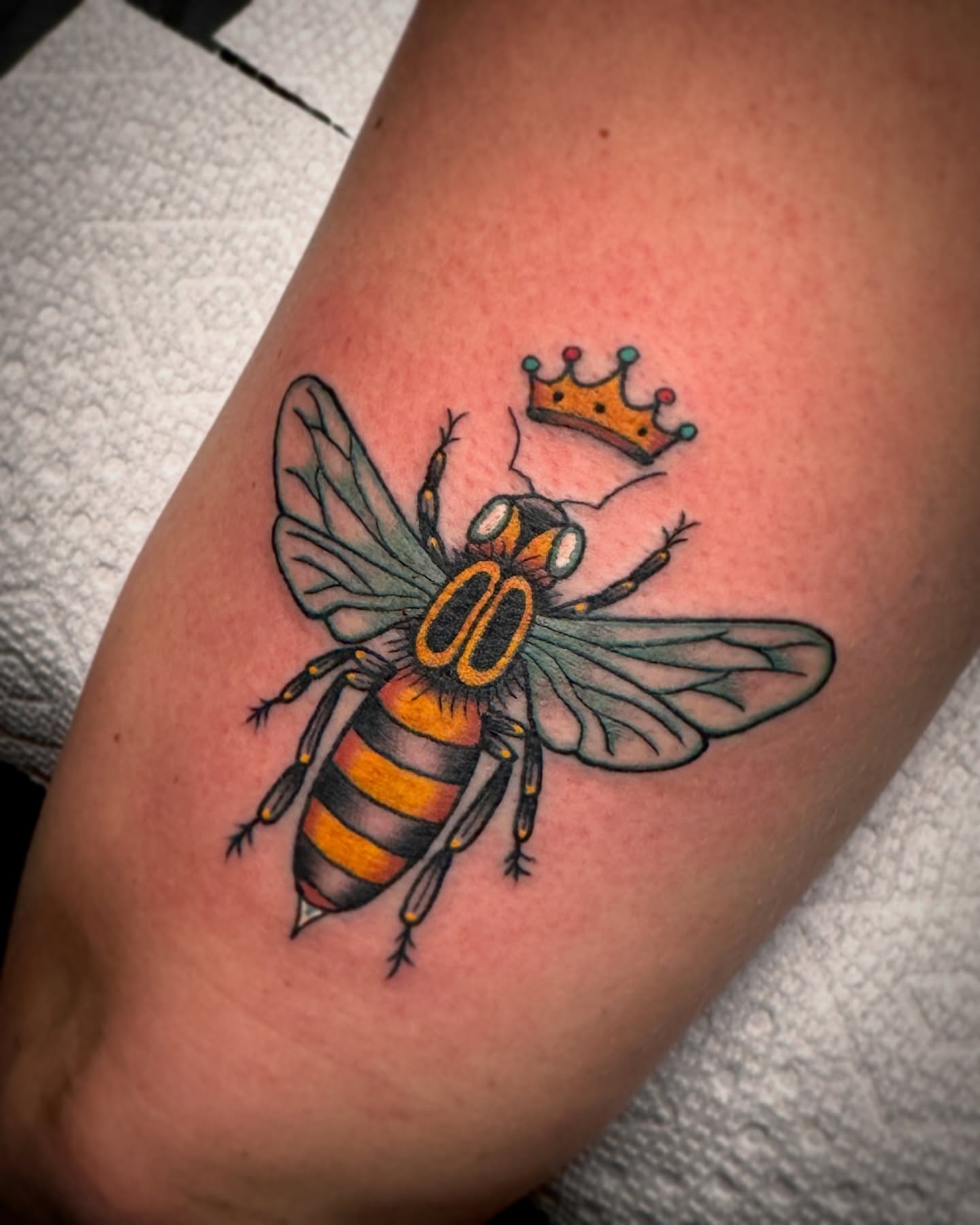 Bee with crown American traditional tattoo on the forearm by Drew McElveney, Austin, Texas