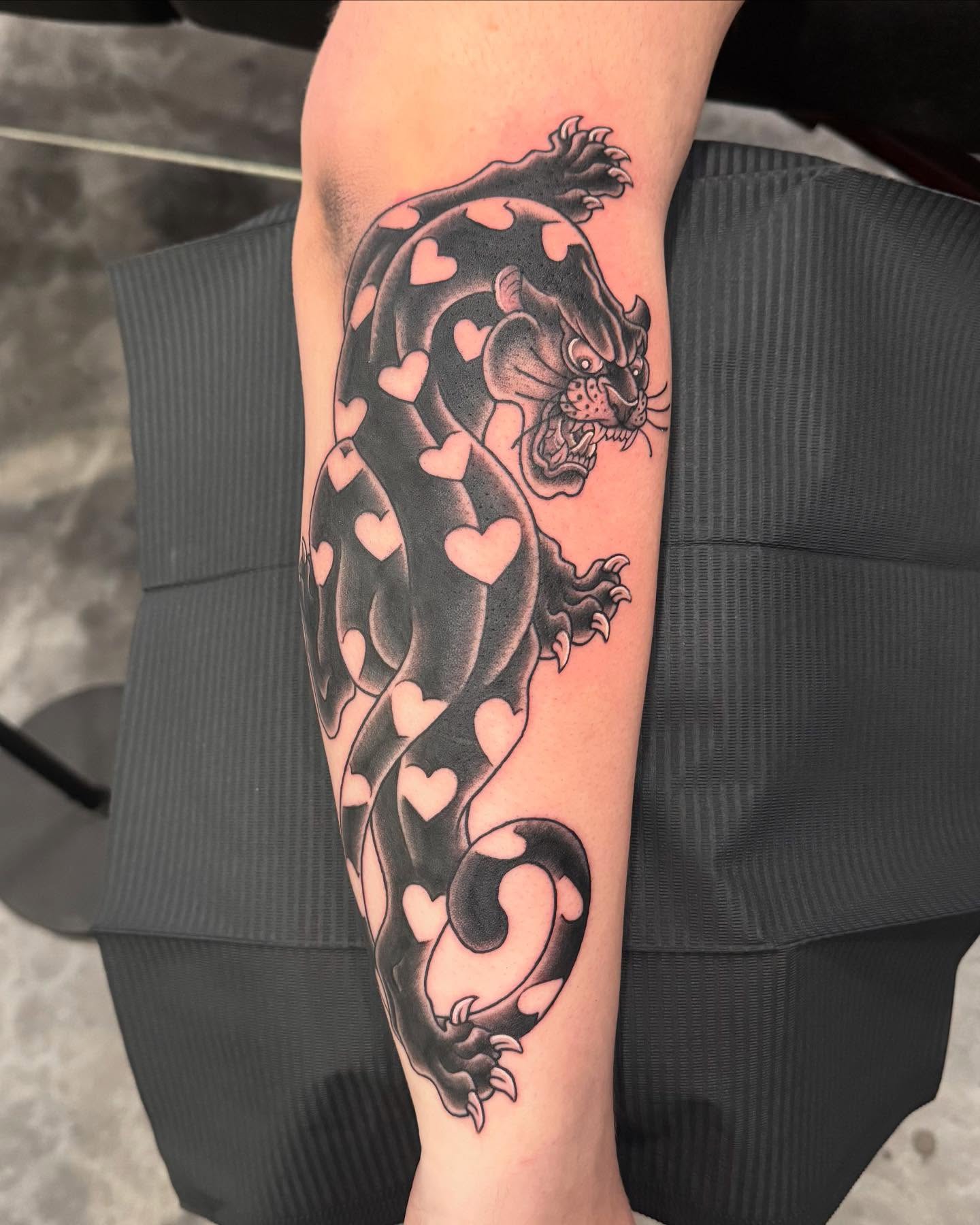 Panther with hearts trash polka tattoo on the forearm by Jay Espinoza-AZ Tattooer