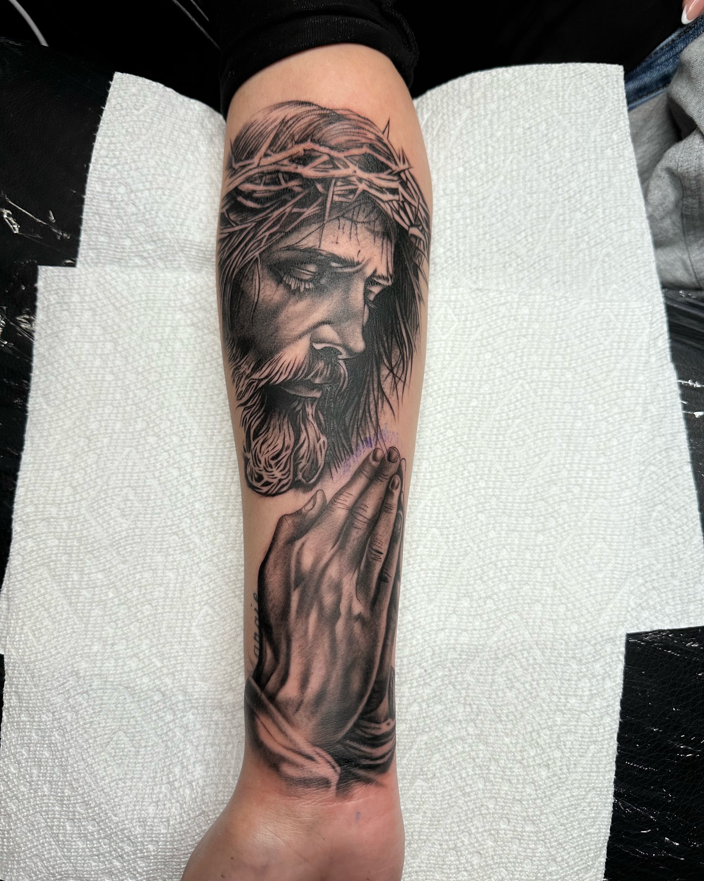 Praying jesus realism tattoo on the forearm by 📍 Austin