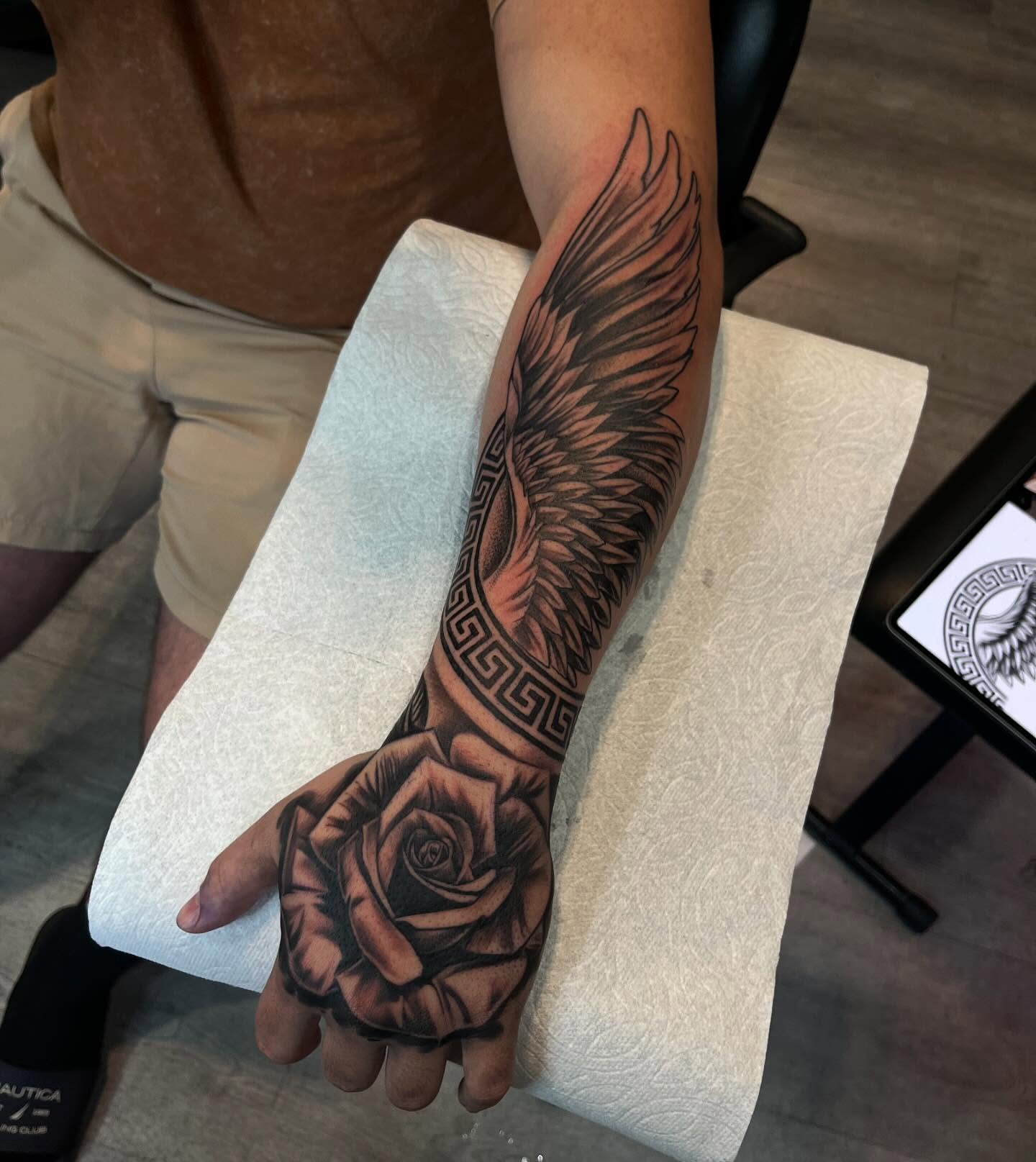 Winged rose realism tattoo on the forearm by michael