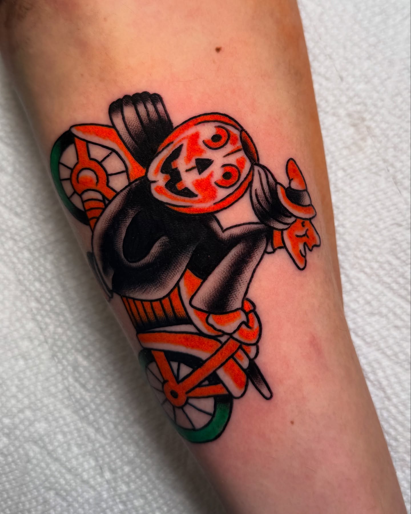 Clown riding bicycle American traditional tattoo on the forearm by πππ’π―π’π¨ πππΆπ©π¬π―π, Manchester, New Hampshire