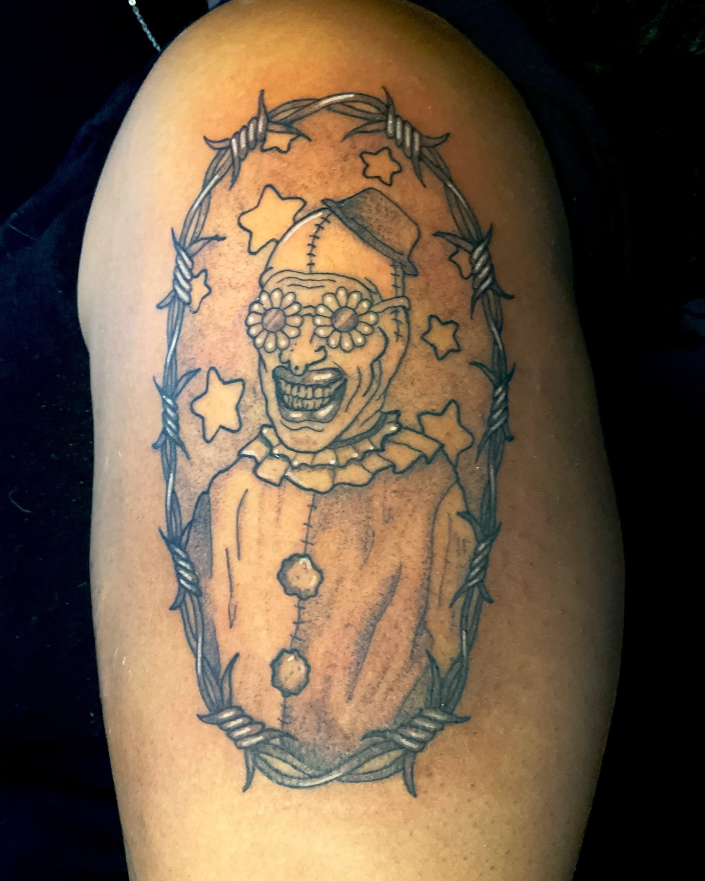 Clown black and grey tattoo on the shoulder by 𝕷𝖚𝖈𝖎𝖉