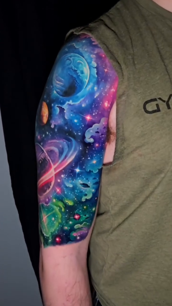 Cosmic scene with planets and nebulae realism tattoo by Tyler Malek