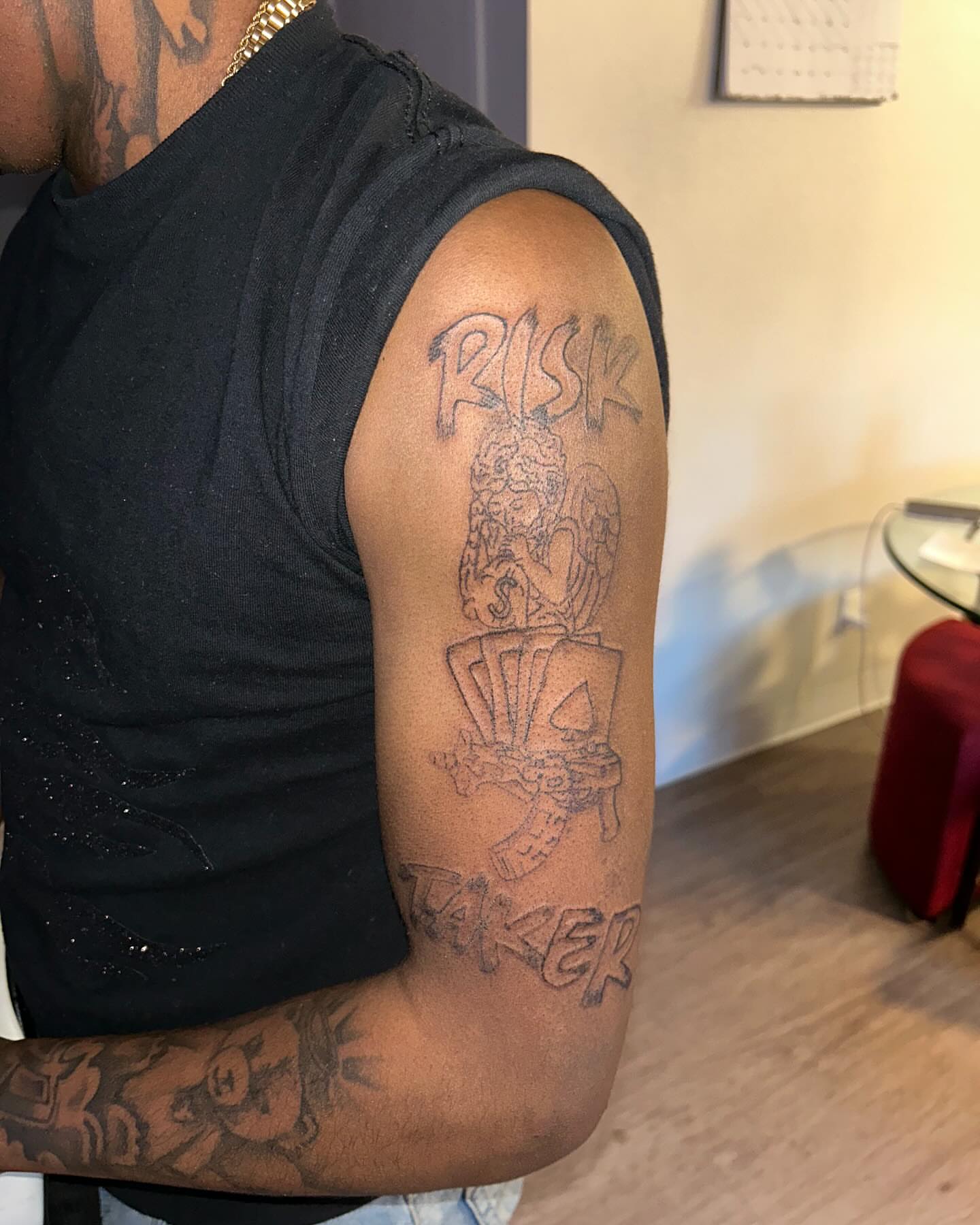Risk taker black and grey tattoo on the upper arm by 702tattoo💉🩸
