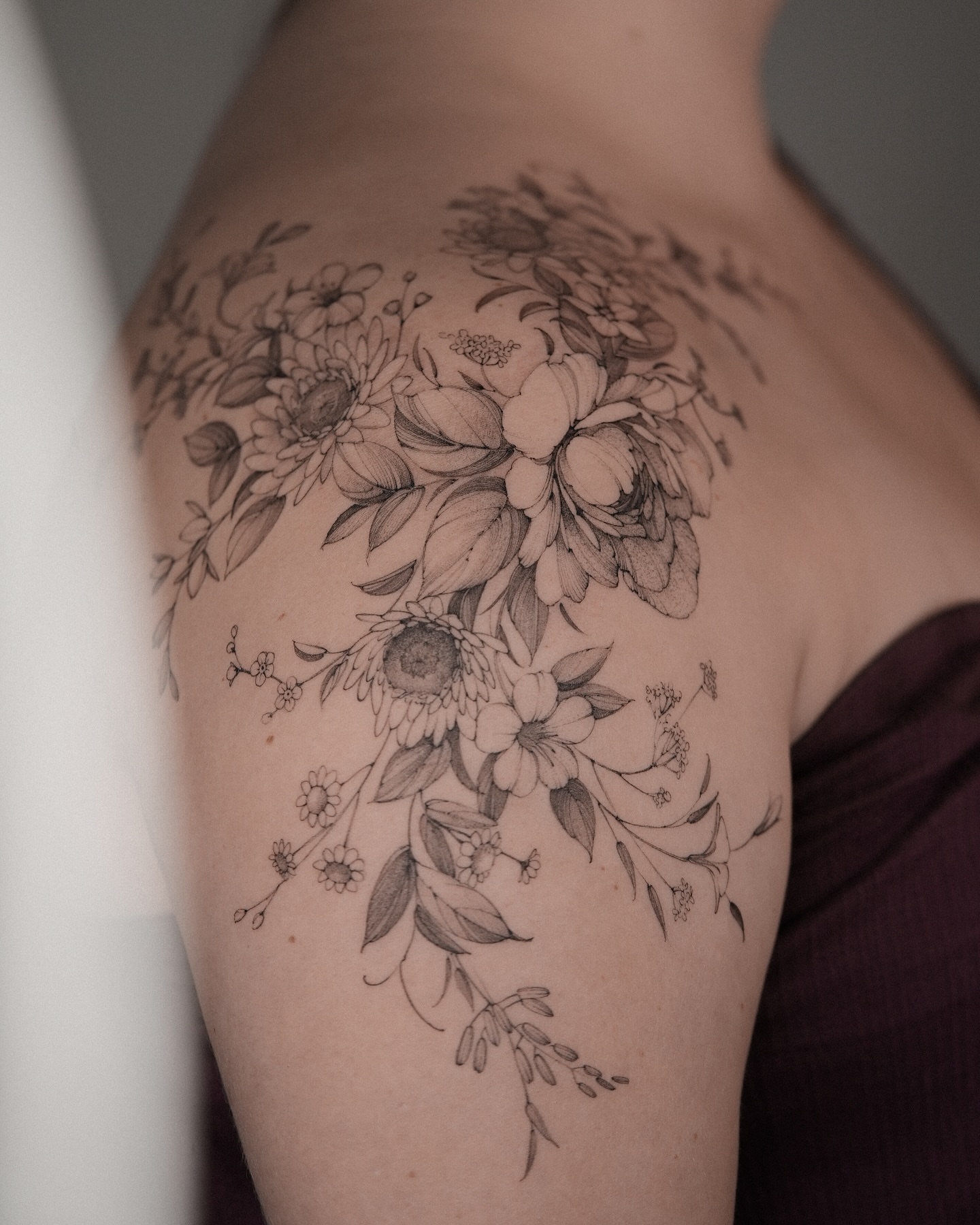 Floral bouquet black and grey tattoo on the shoulder by Mary Shekh