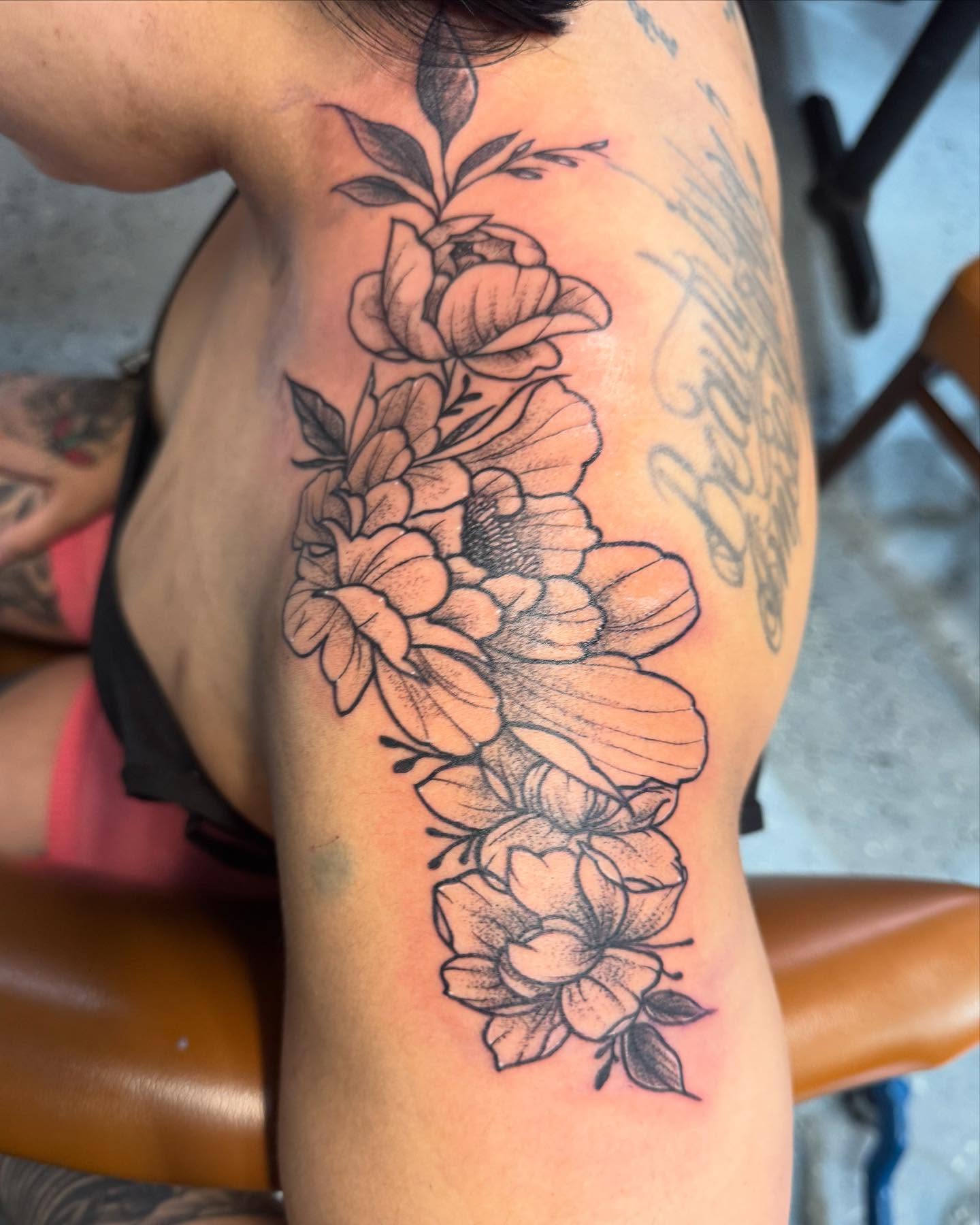Floral bouquet black and grey tattoo on the upper arm by Fire-Breathing Bitch Queen