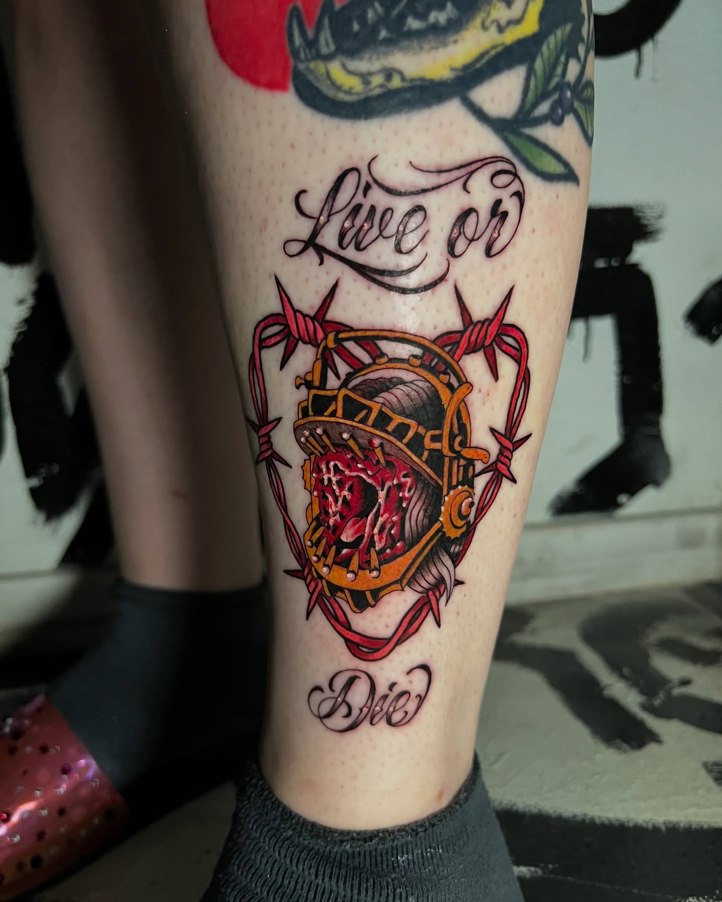 Barbed wire and heart American traditional tattoo on the calf by Brittney