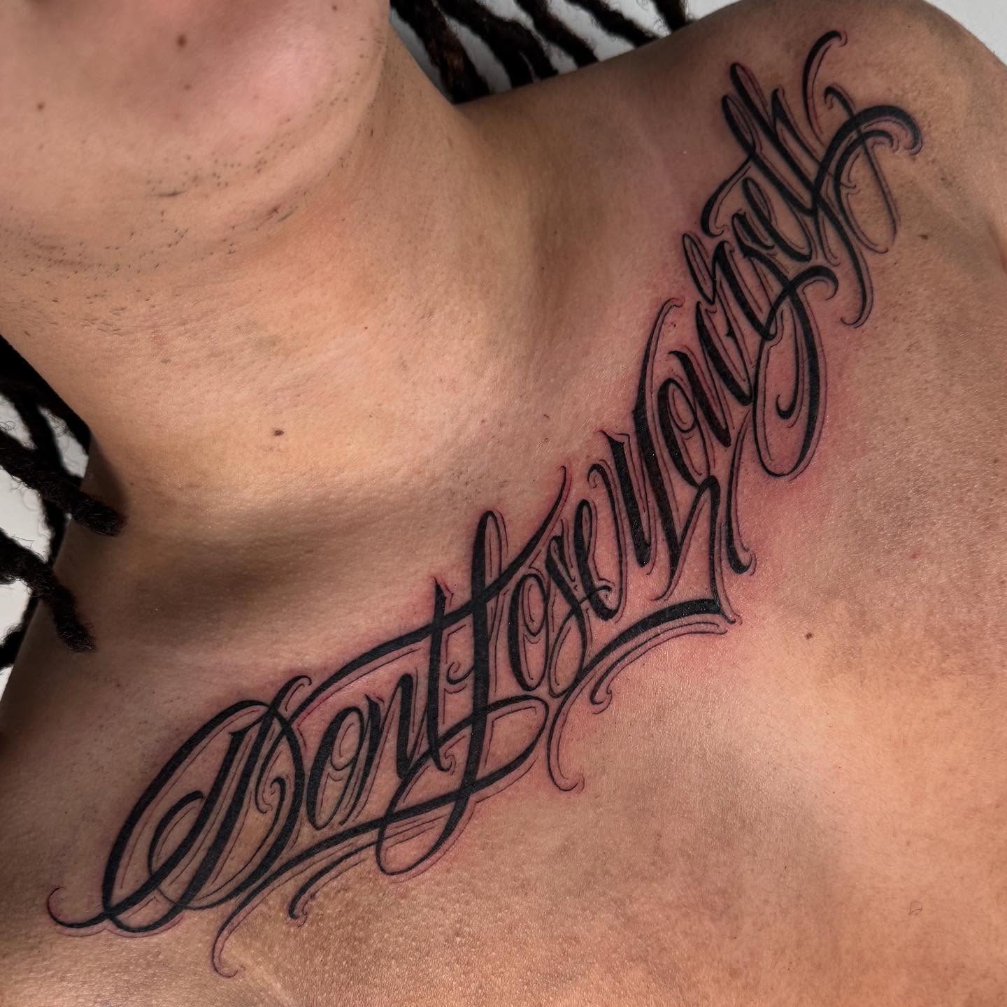 Don't lose yourself lettering script tattoo on the chest by Chicanocustomlettering