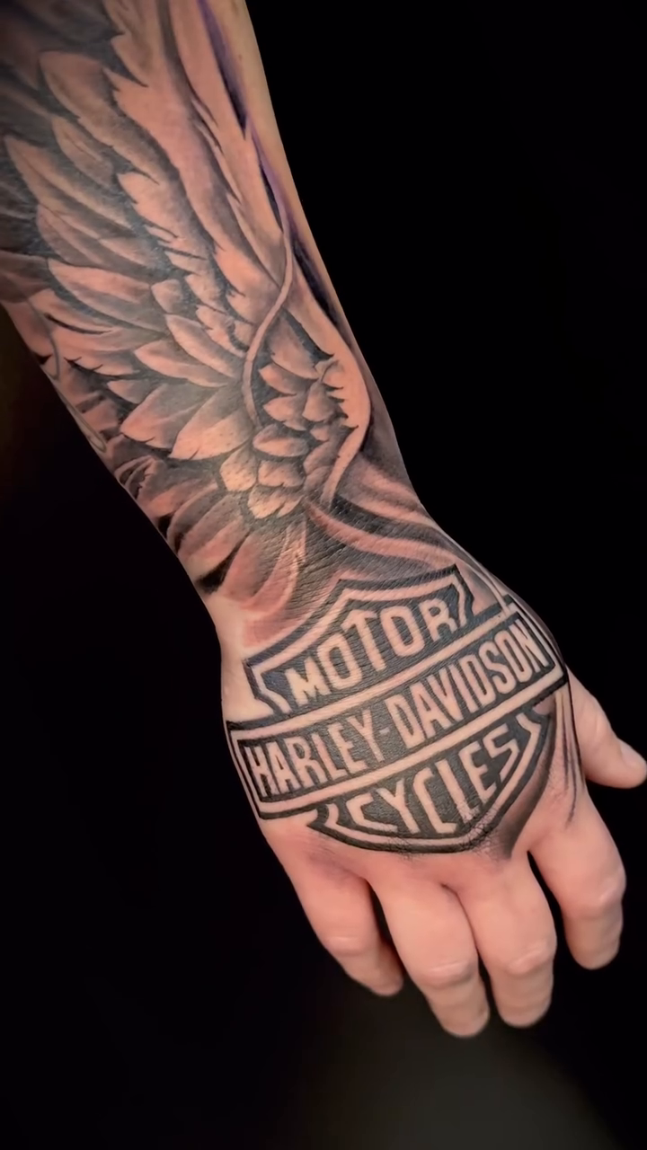 Harley Davidson logo with wings realism tattoo by Sacramento Tattoo Artist Ryan