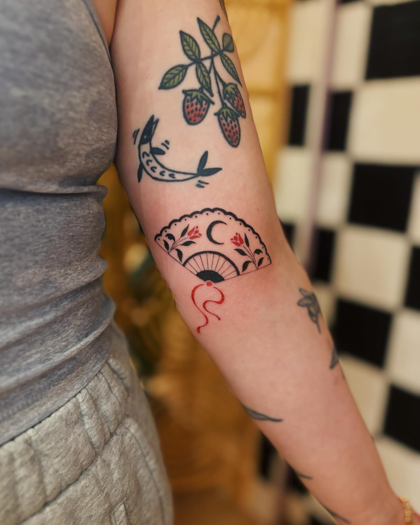 Strawberries and fish American traditional tattoo on the forearm by b i l l i e, Seattle, Washington