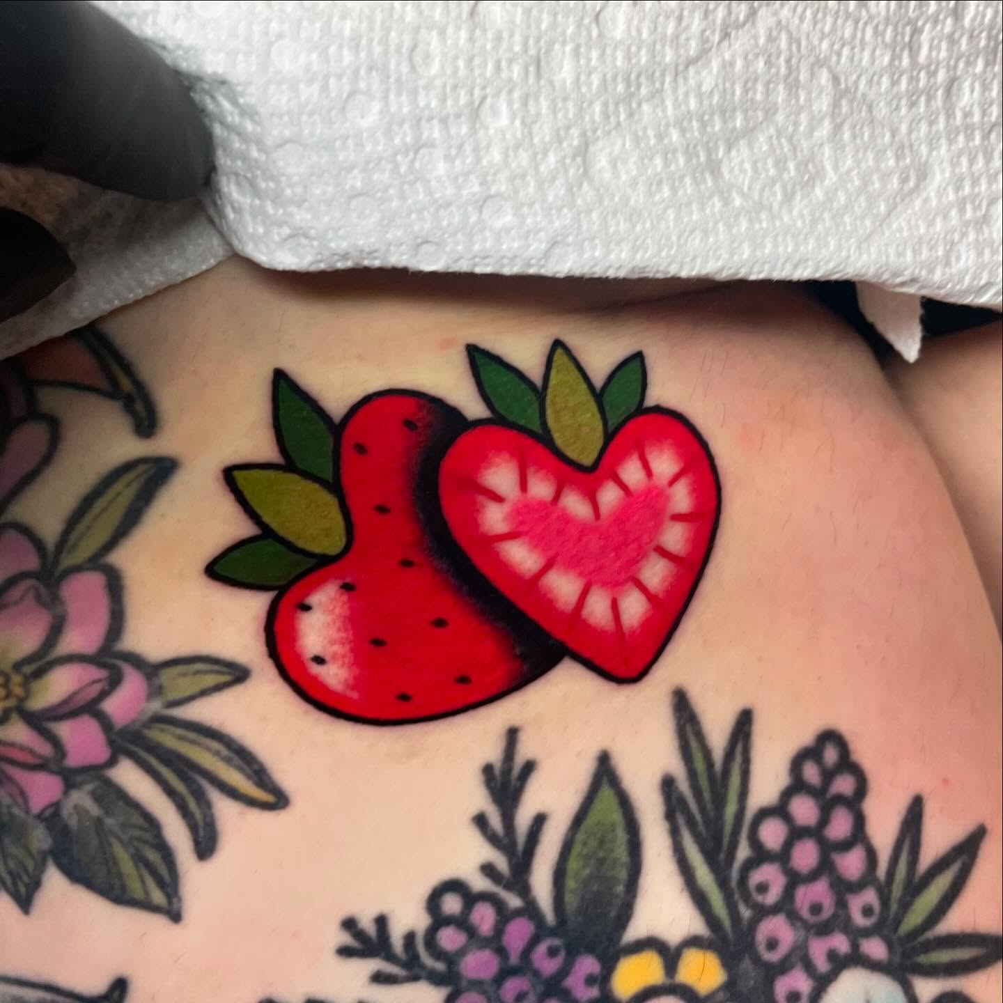 Strawberry American traditional tattoo on the thigh by Nova Vaughn