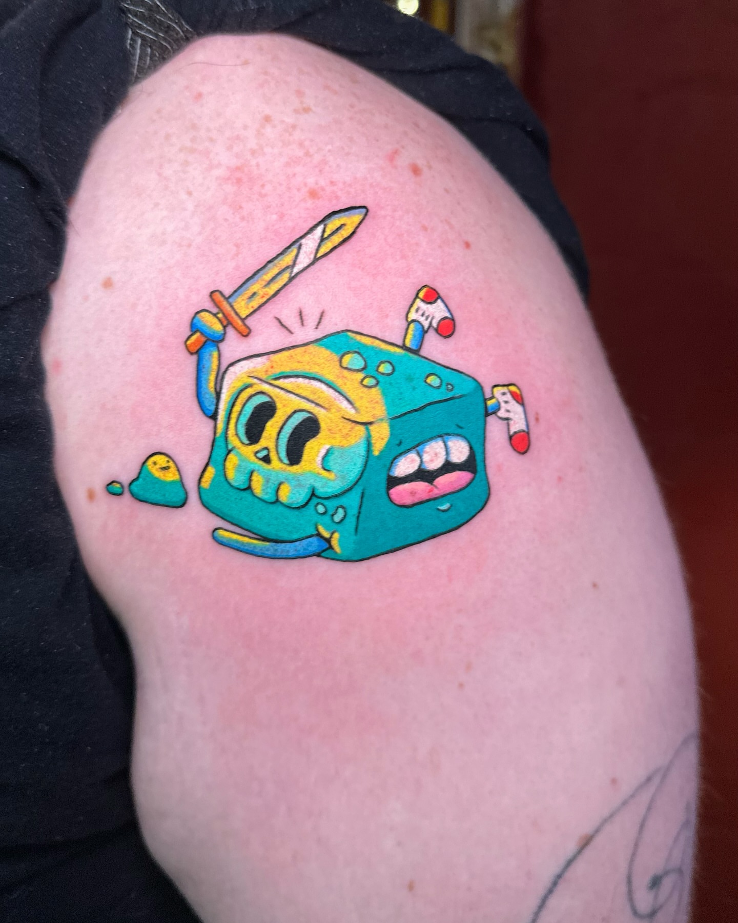 Spongebob squarepants new school tattoo on the upper arm by Kellie Burch
