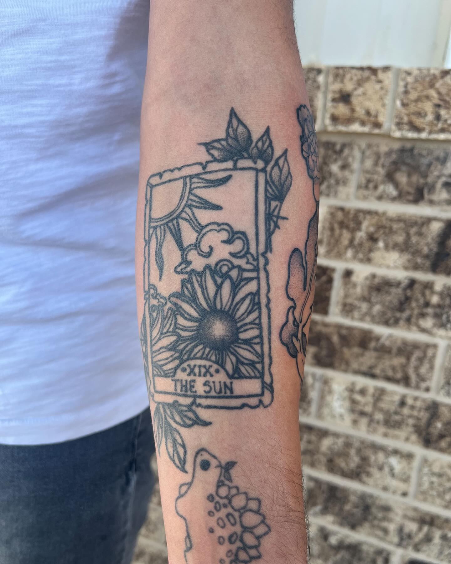 The sun tarot card black and grey tattoo on the forearm by ty ☆ nbtx tattoo artist