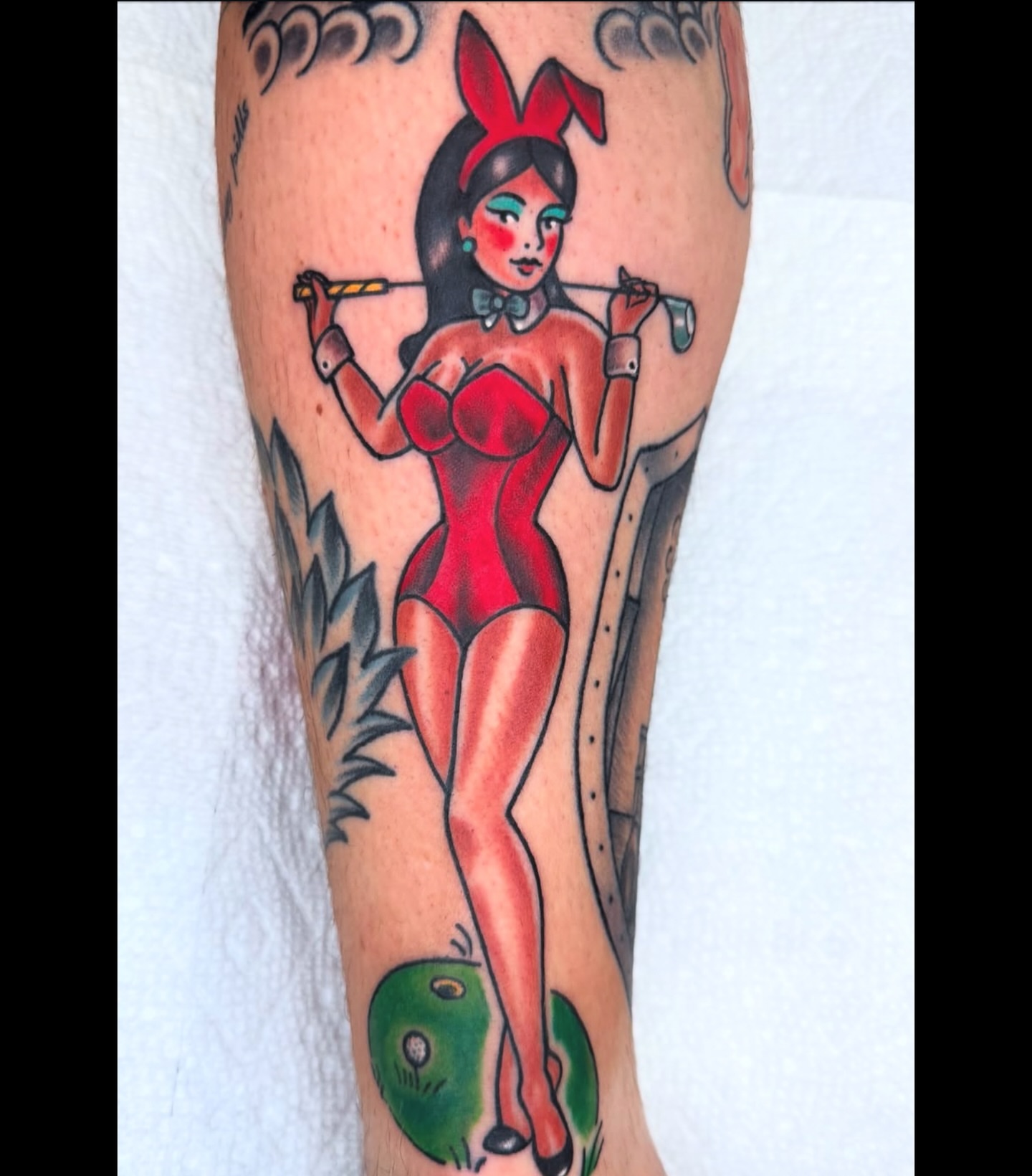 Pin-up girl American traditional tattoo on the forearm by Lisa Del Toro