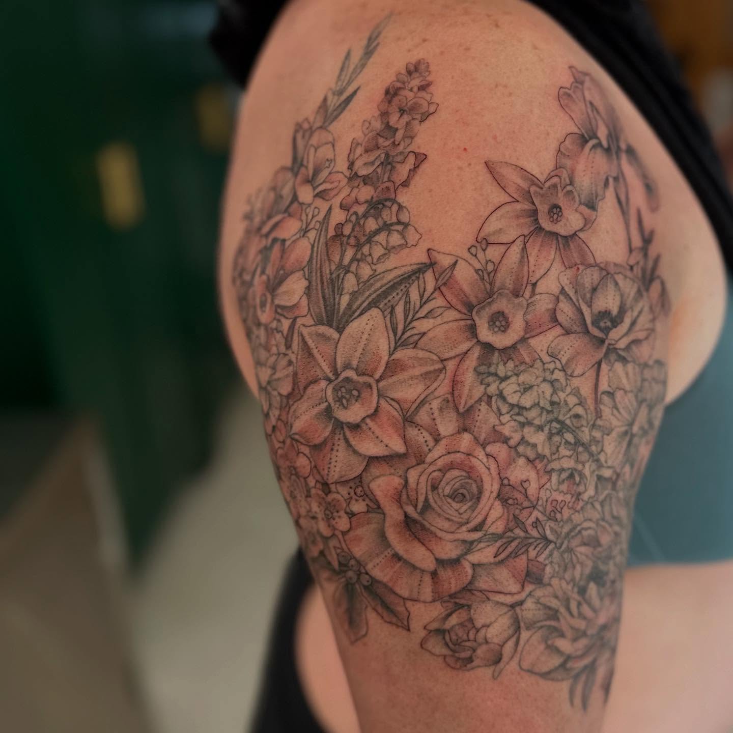 Floral bouquet realism tattoo on the shoulder by Abigail Townsend