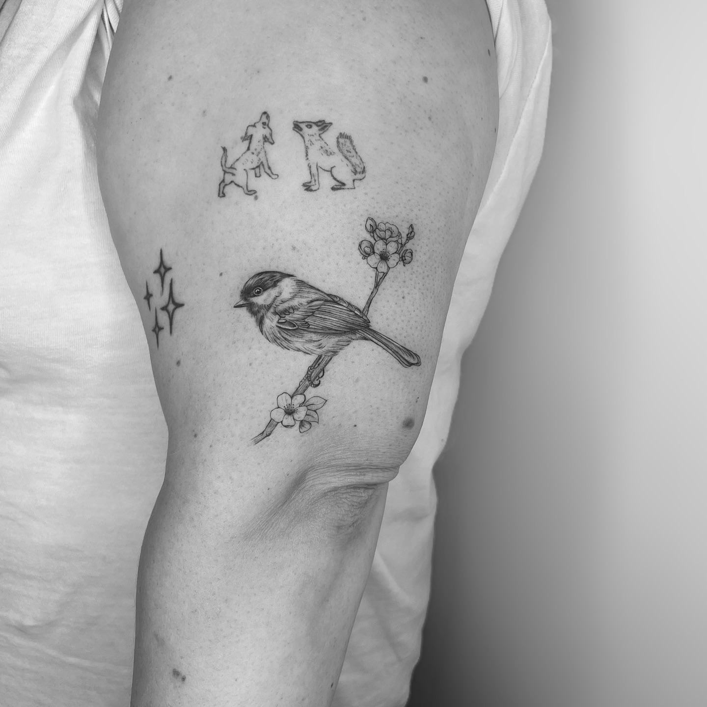 Bird and flowers black and grey tattoo on the forearm by Marisa Martello, Nashville, Tennessee