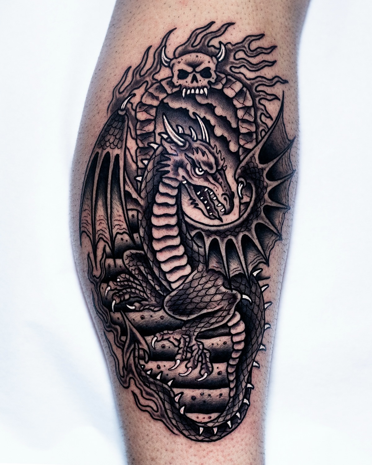 Dragon black and grey tattoo on the forearm by Miguel Comin