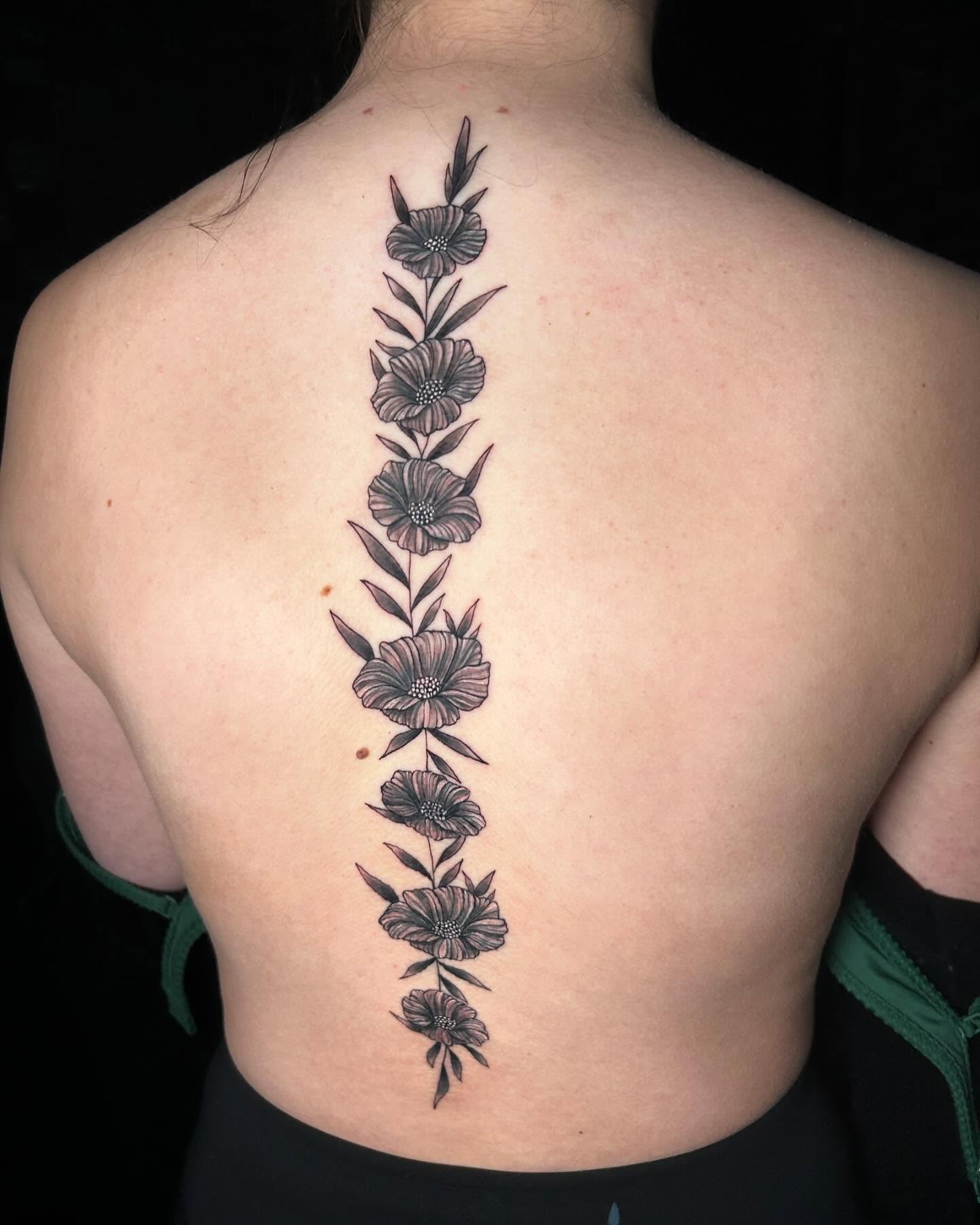 Flowers black and grey tattoo on the back by Brittany Brutal