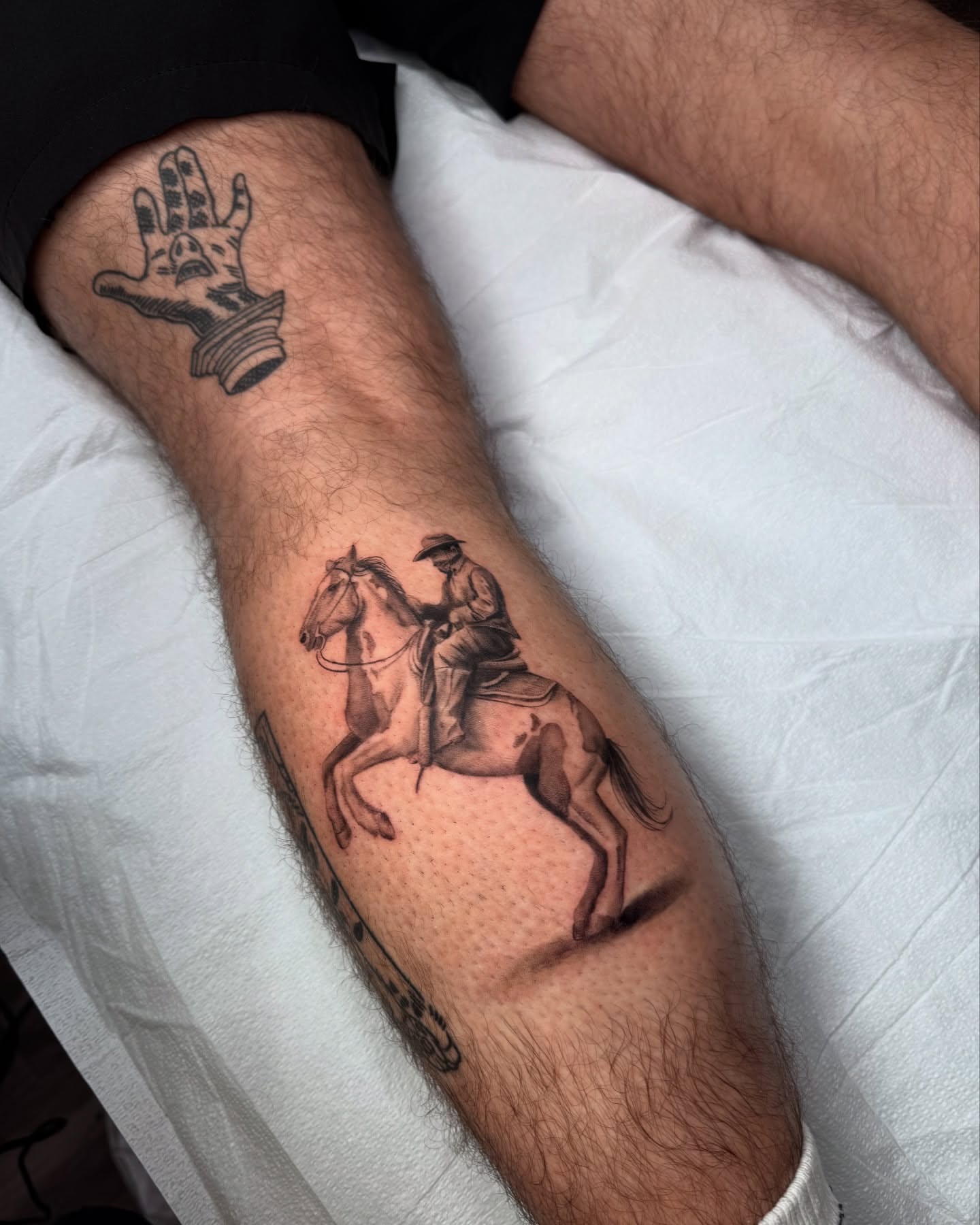 Rider on horse realism tattoo on the forearm by Truett Payton