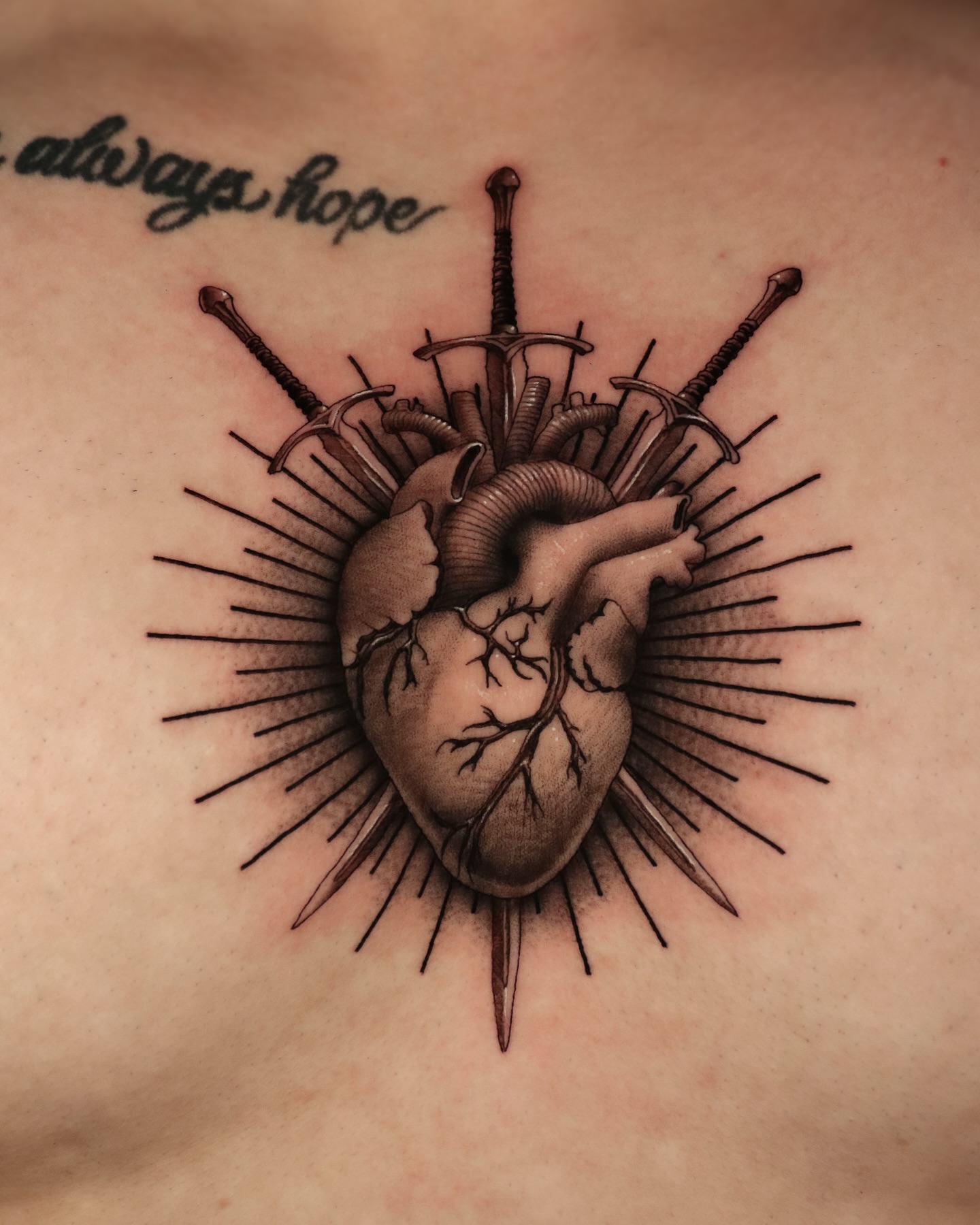 Heart with swords realism tattoo on the chest by Jeff Reindel