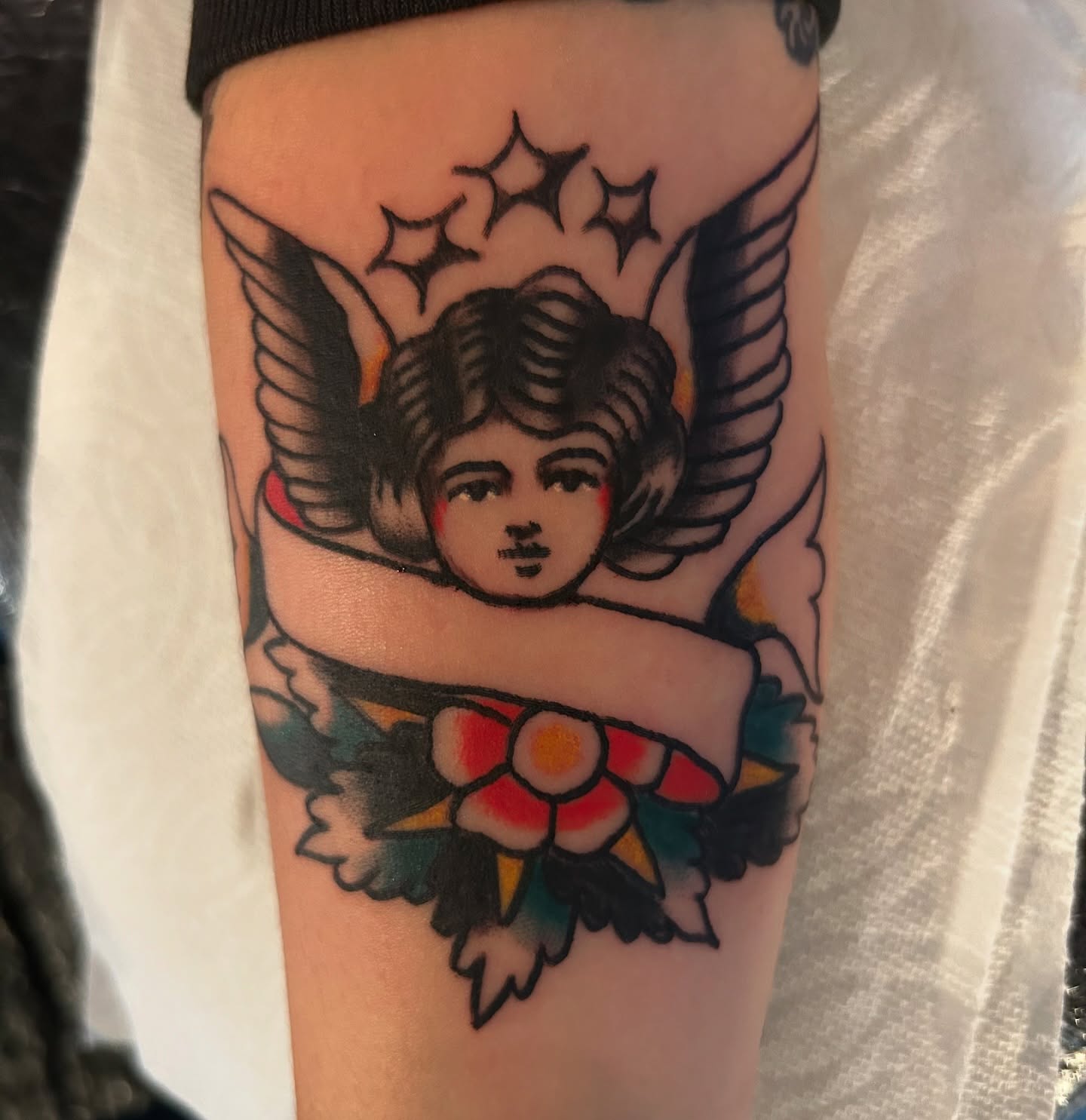 Cherub American traditional tattoo on the forearm by Joey Delarosa, San Francisco, California
