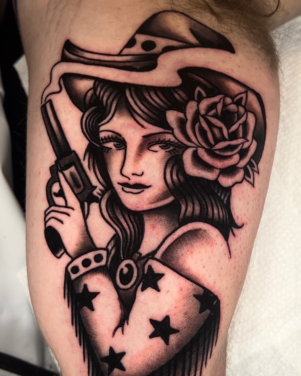 Woman with revolver American traditional tattoo on the forearm by Cory Allen