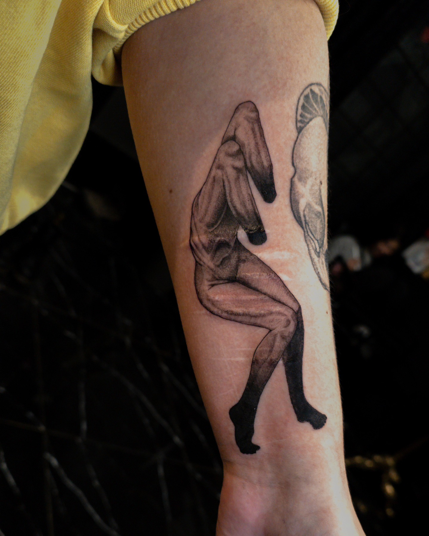 Nude female figure realism tattoo on the forearm by EyeSee Tattoos