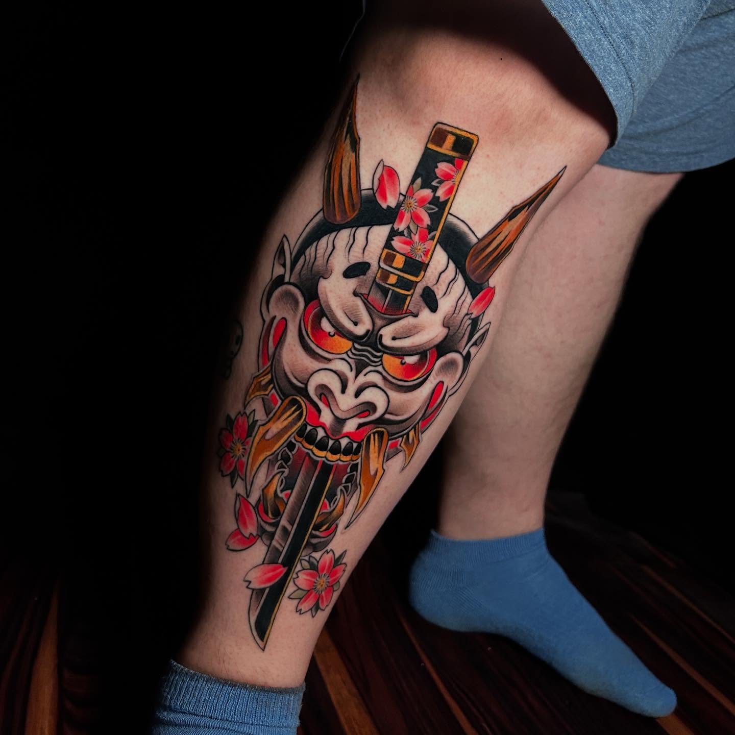 Mask with swords American traditional tattoo on the thigh by Rat Girl, Dayton, Ohio
