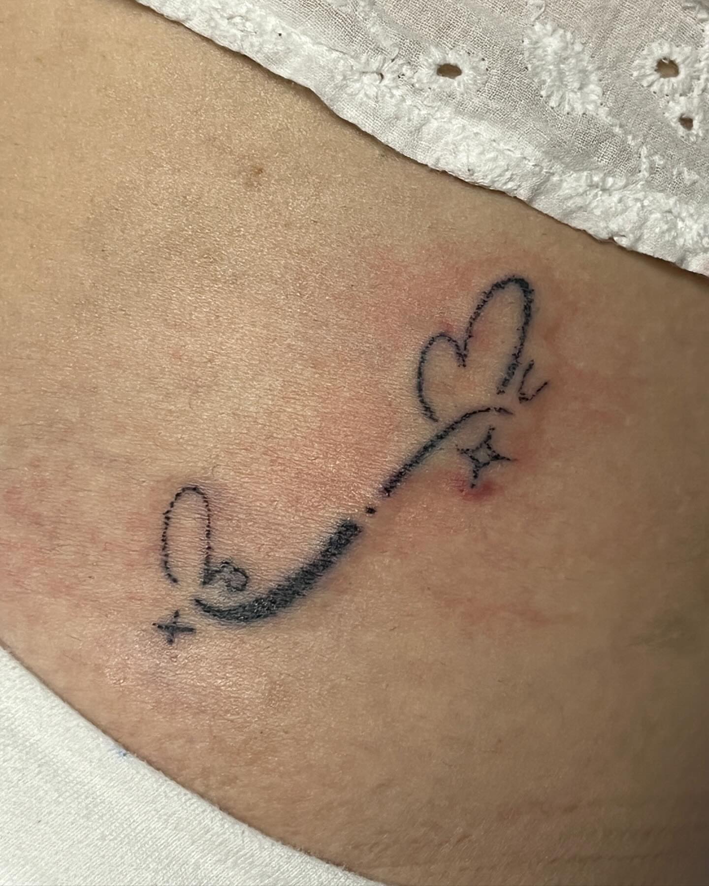 Heart and arrow black and grey tattoo on the ribs by hana