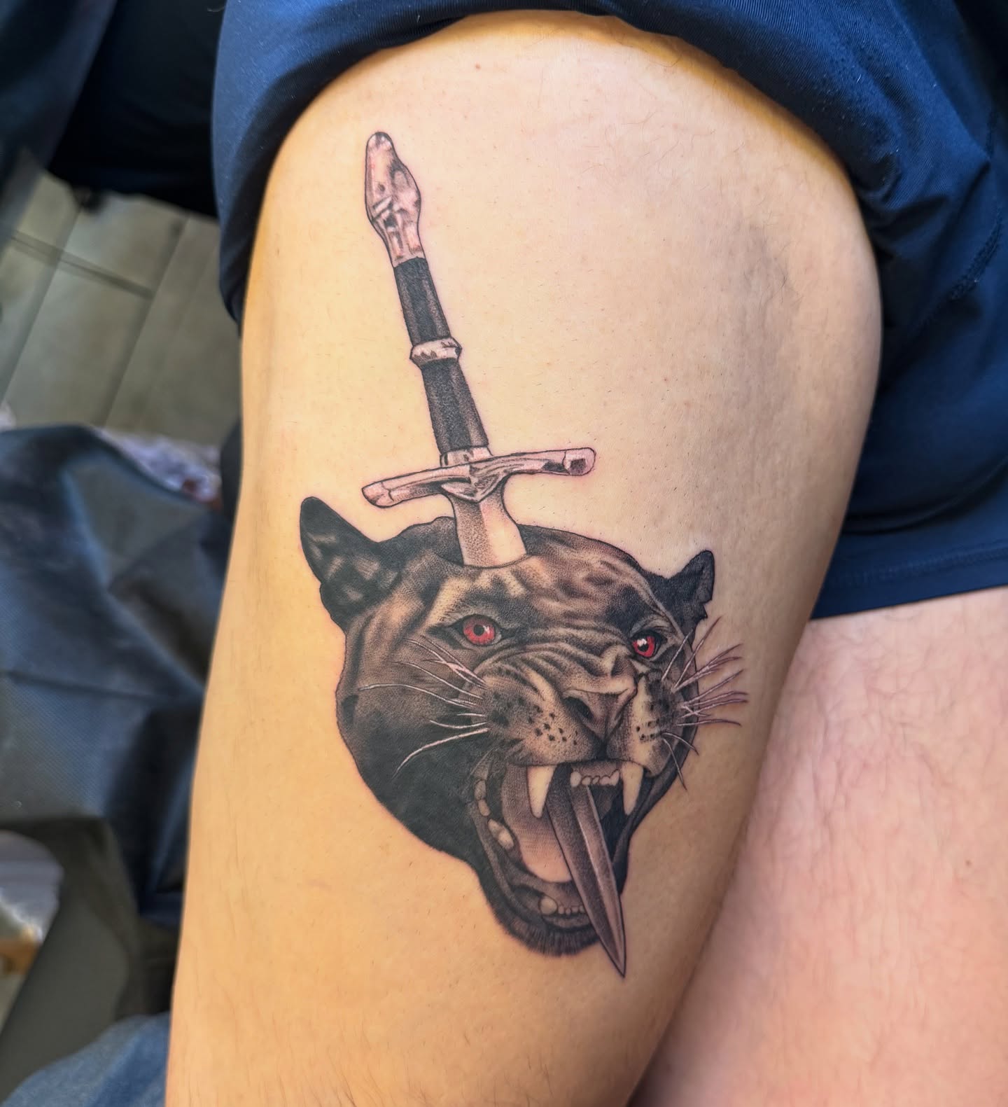 Panther with sword realism tattoo on the thigh by Jesse Reip, Lakewood, Ohio