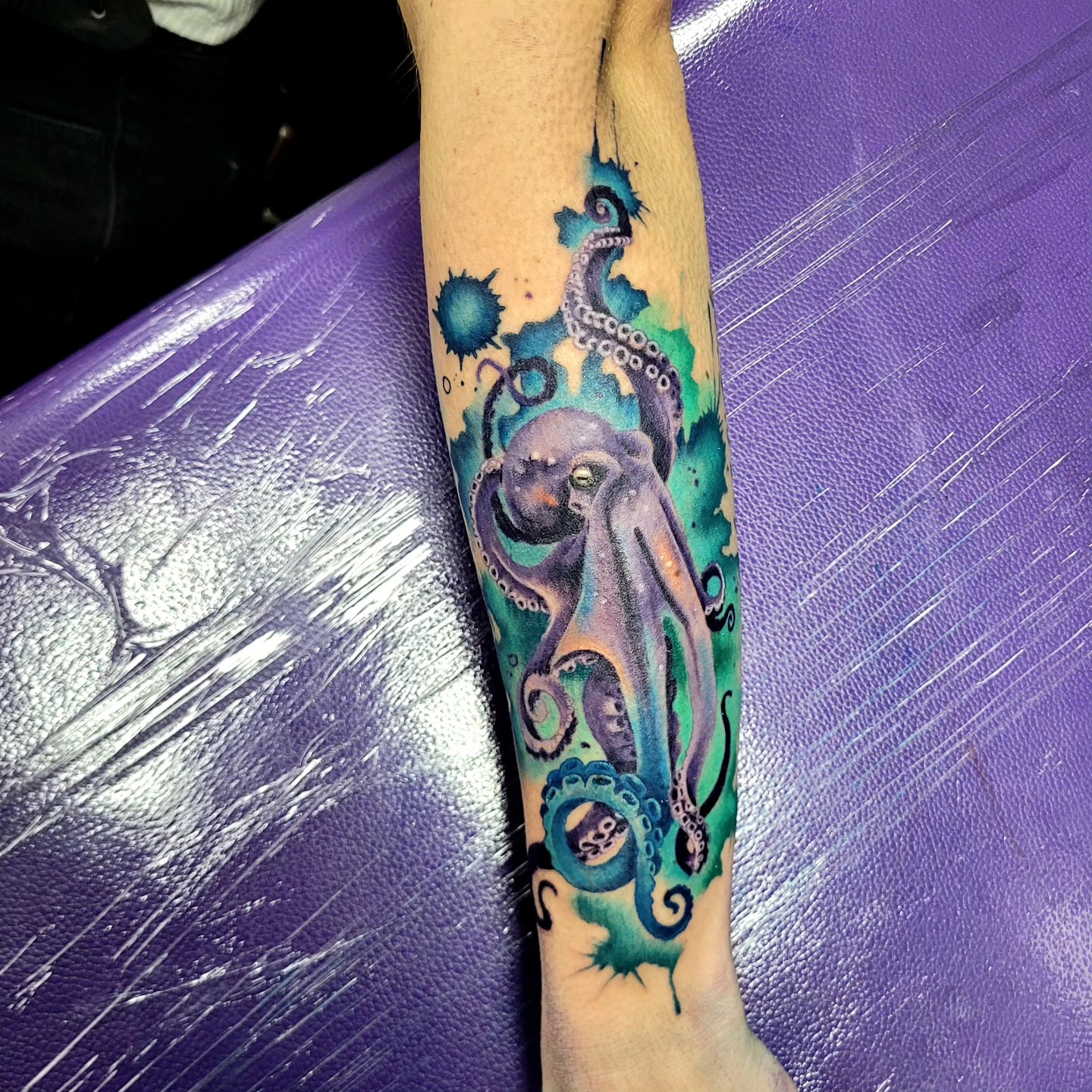 Octopus watercolor tattoo on the forearm by Jentrey McCausland