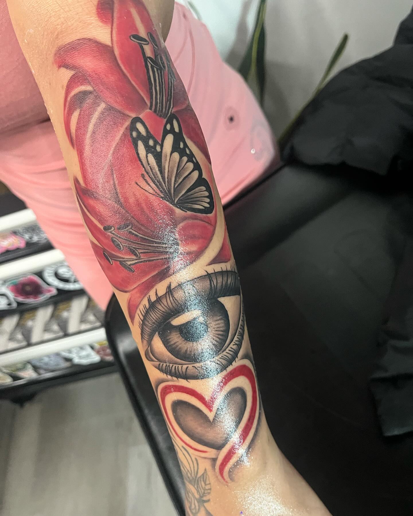 Eye and heart realism tattoo on the forearm by Detroit Tattoo Artist