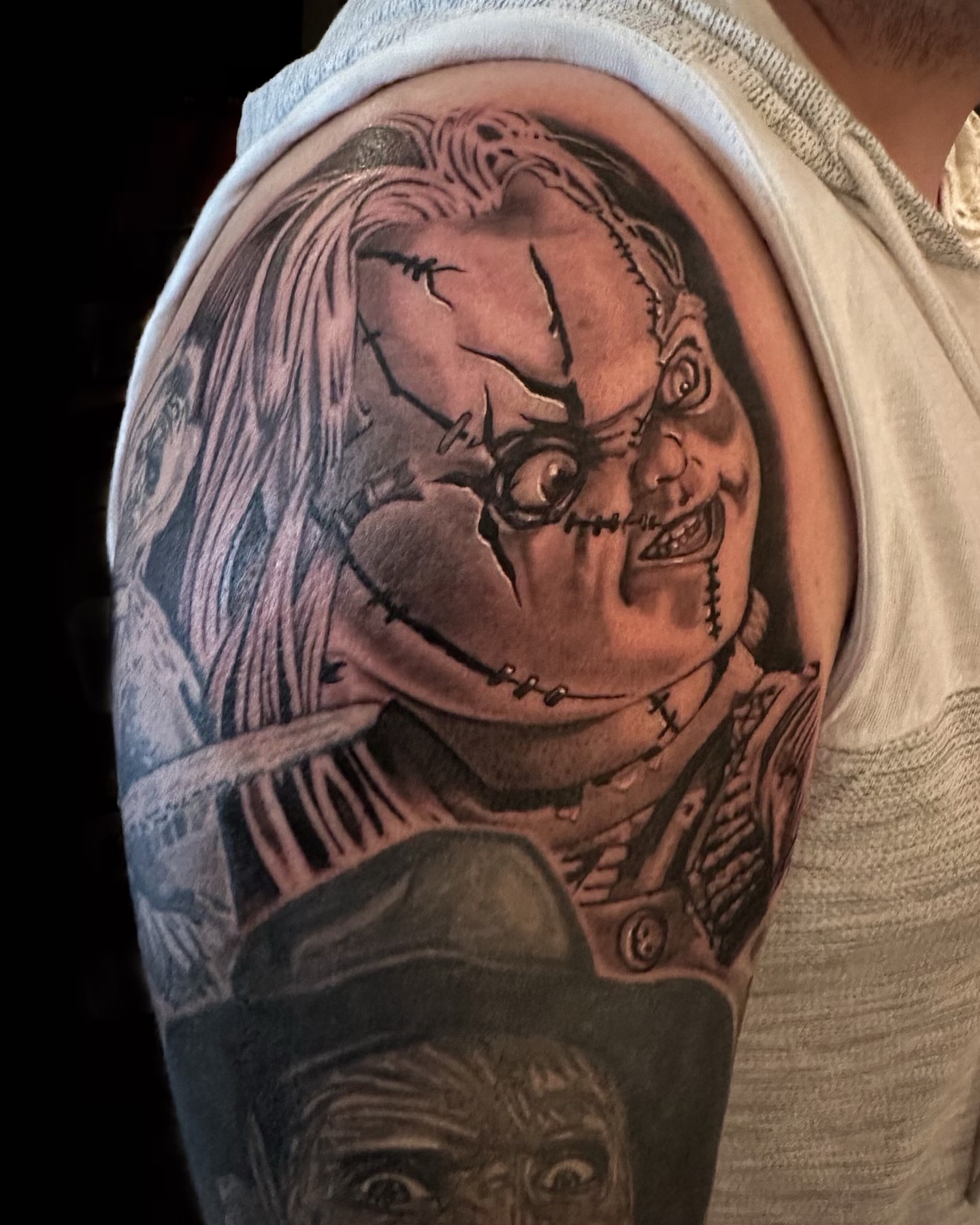 Chucky realism tattoo on the upper arm by las vegas tattoo artist
