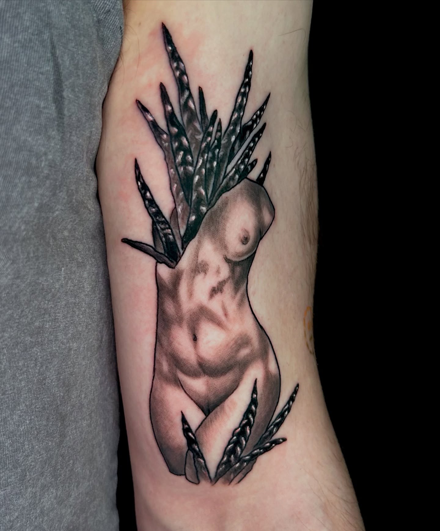 Nude female figure with wheat realism tattoo on the forearm by Laura Babsie