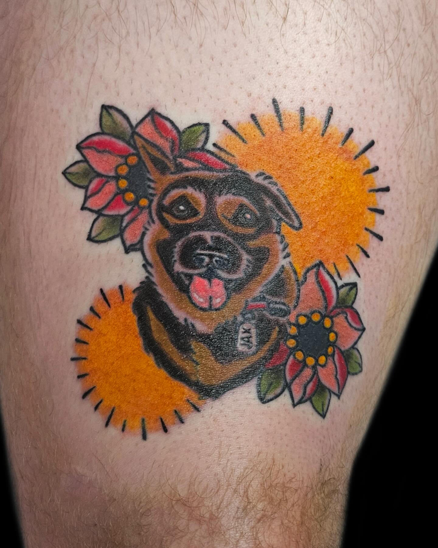 Dog with flowers American traditional tattoo on the thigh by J. Arturo Laparra