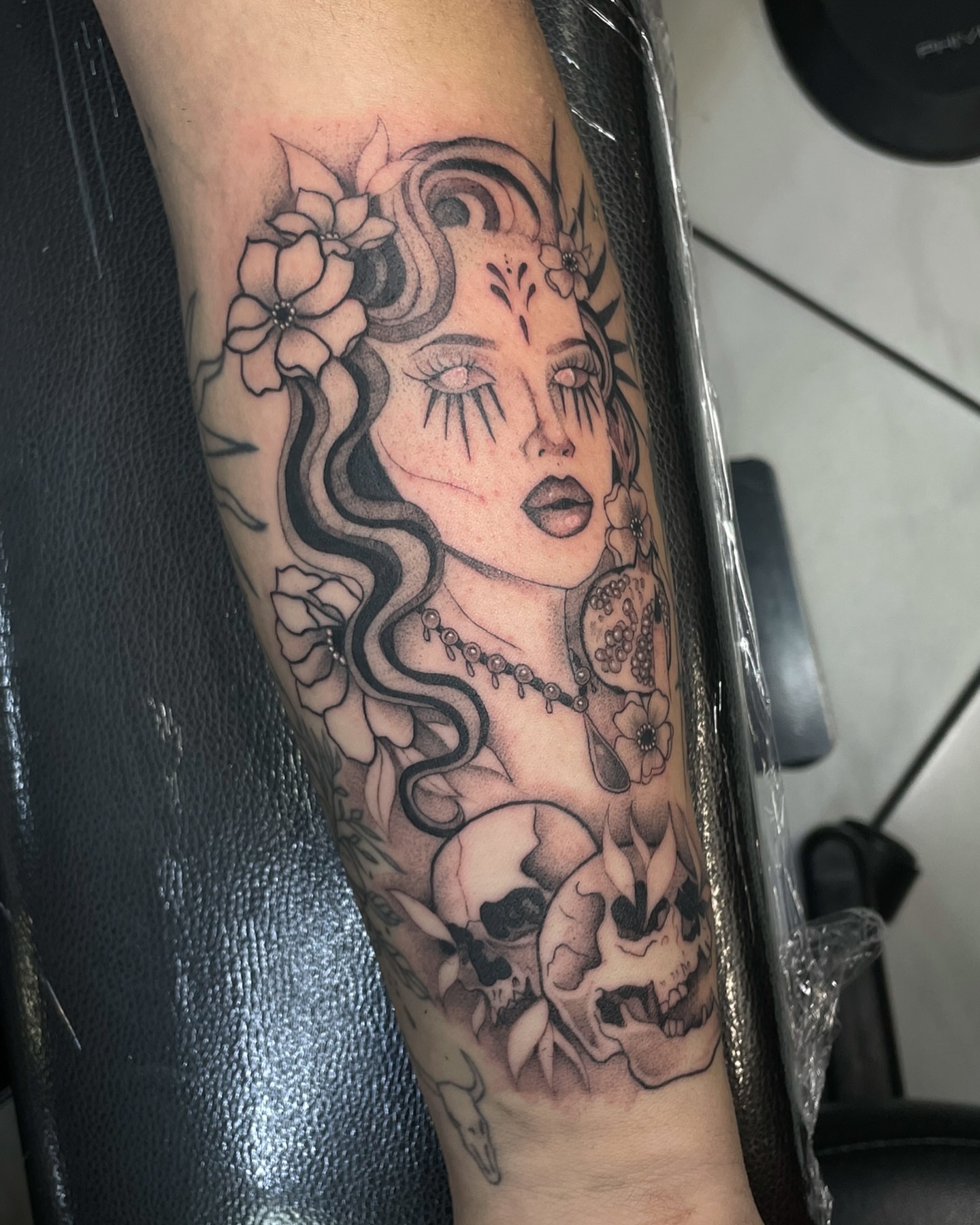 Woman with skulls realism tattoo on the forearm by Marie π Tattoos