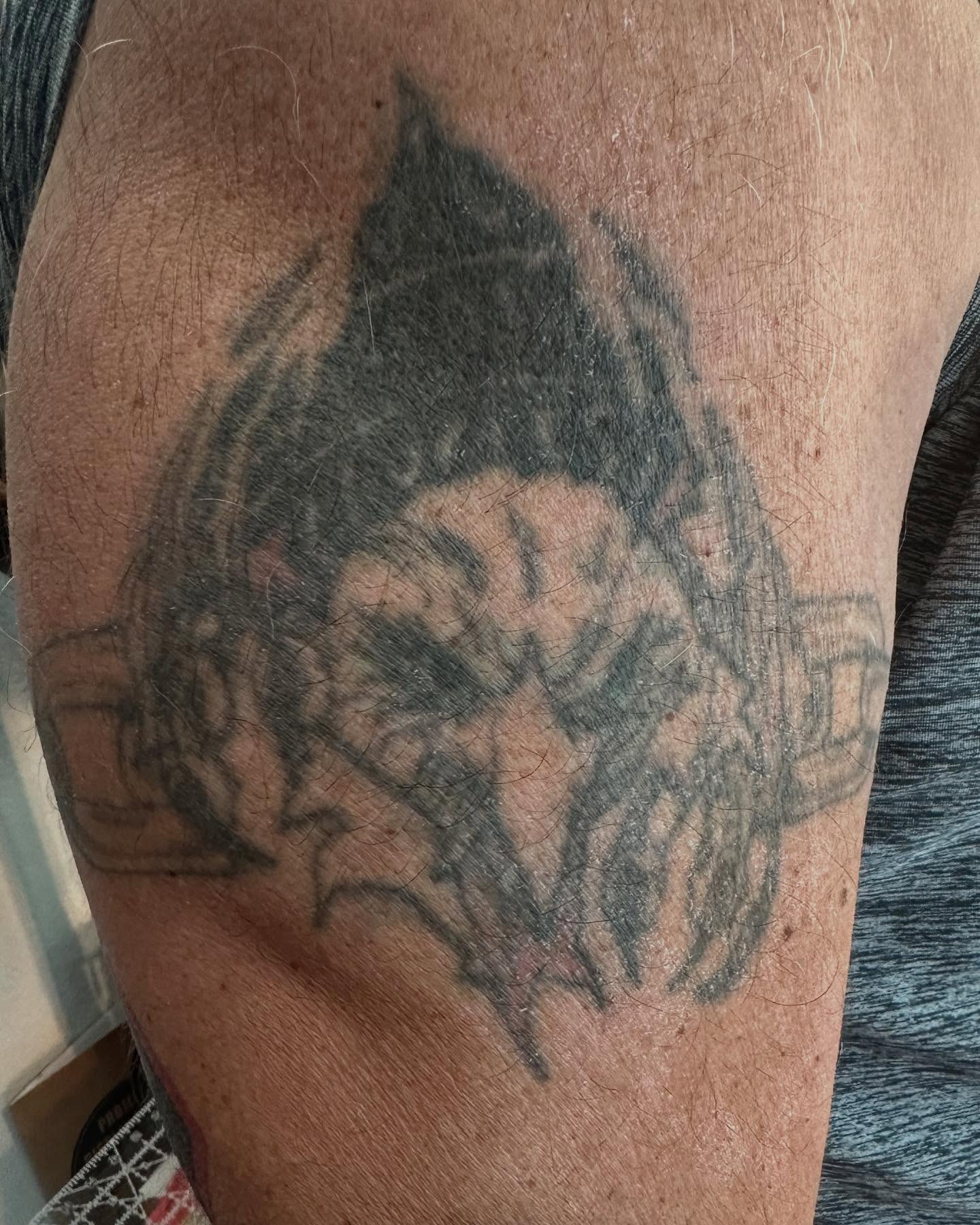 Skull black and grey tattoo on the upper arm by 𝕯𝖗𝖆𝕶𝖊㋛