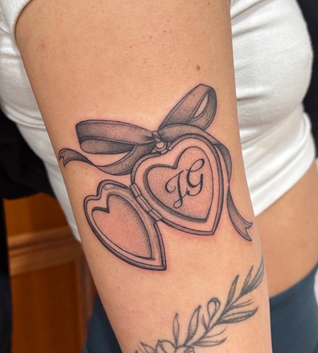 Heart locket black and grey tattoo on the forearm by Alicia