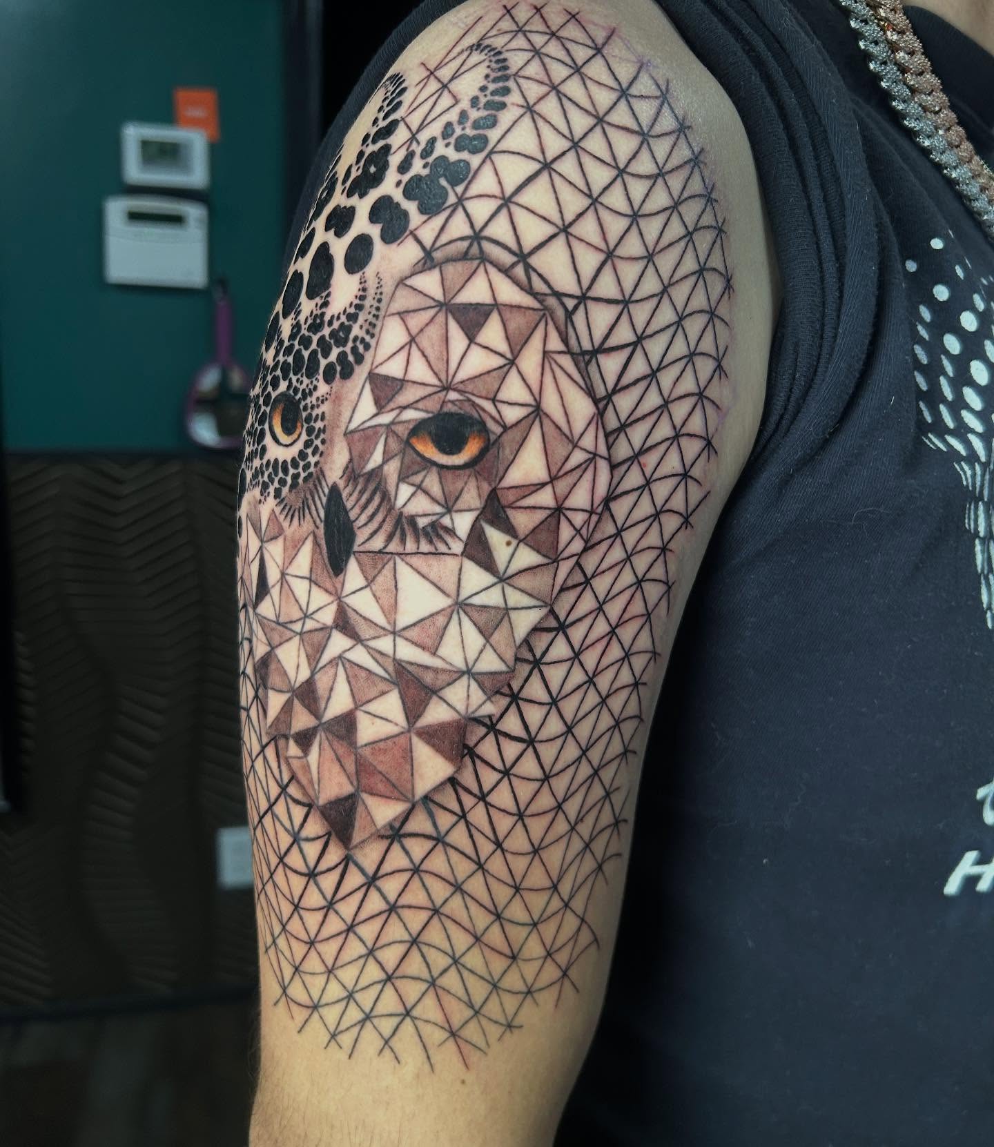 Owl geometric tattoo on the upper arm by Katarina Gorchov Negrón