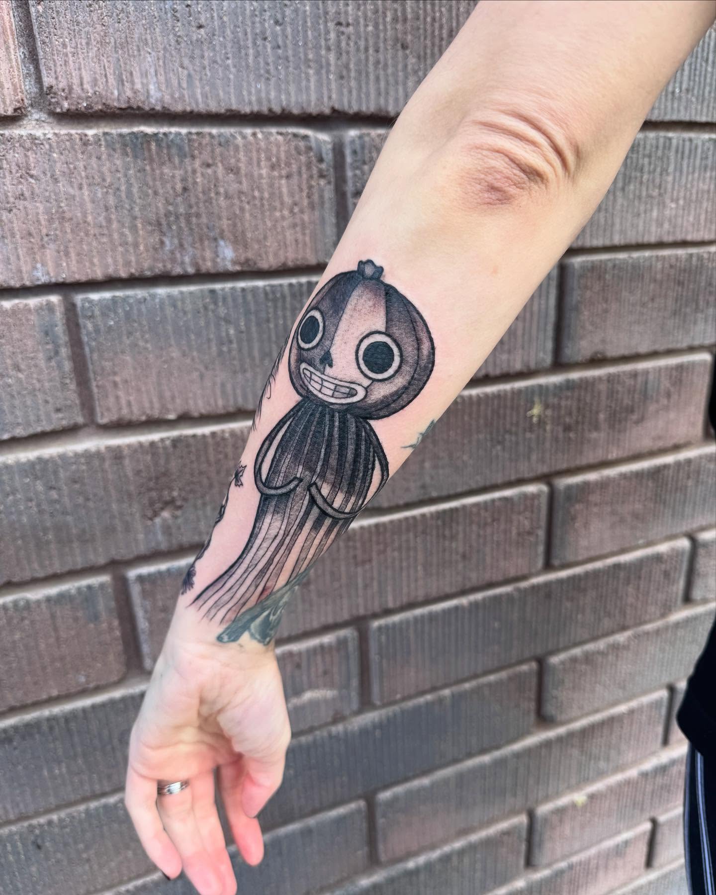 Octopus black and grey tattoo on the forearm by Jianna