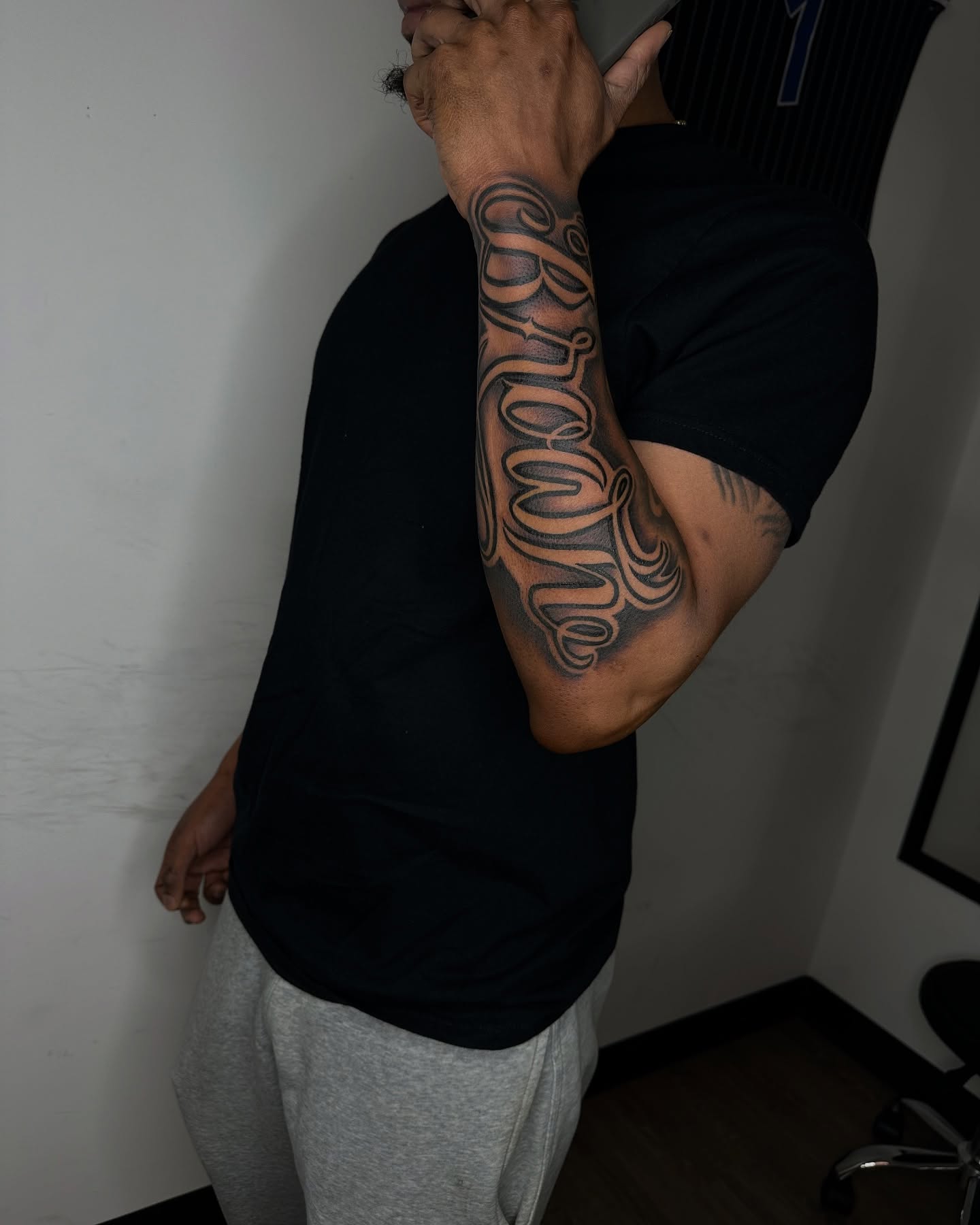 Script lettering lettering script tattoo on the upper arm by Vonte Seay