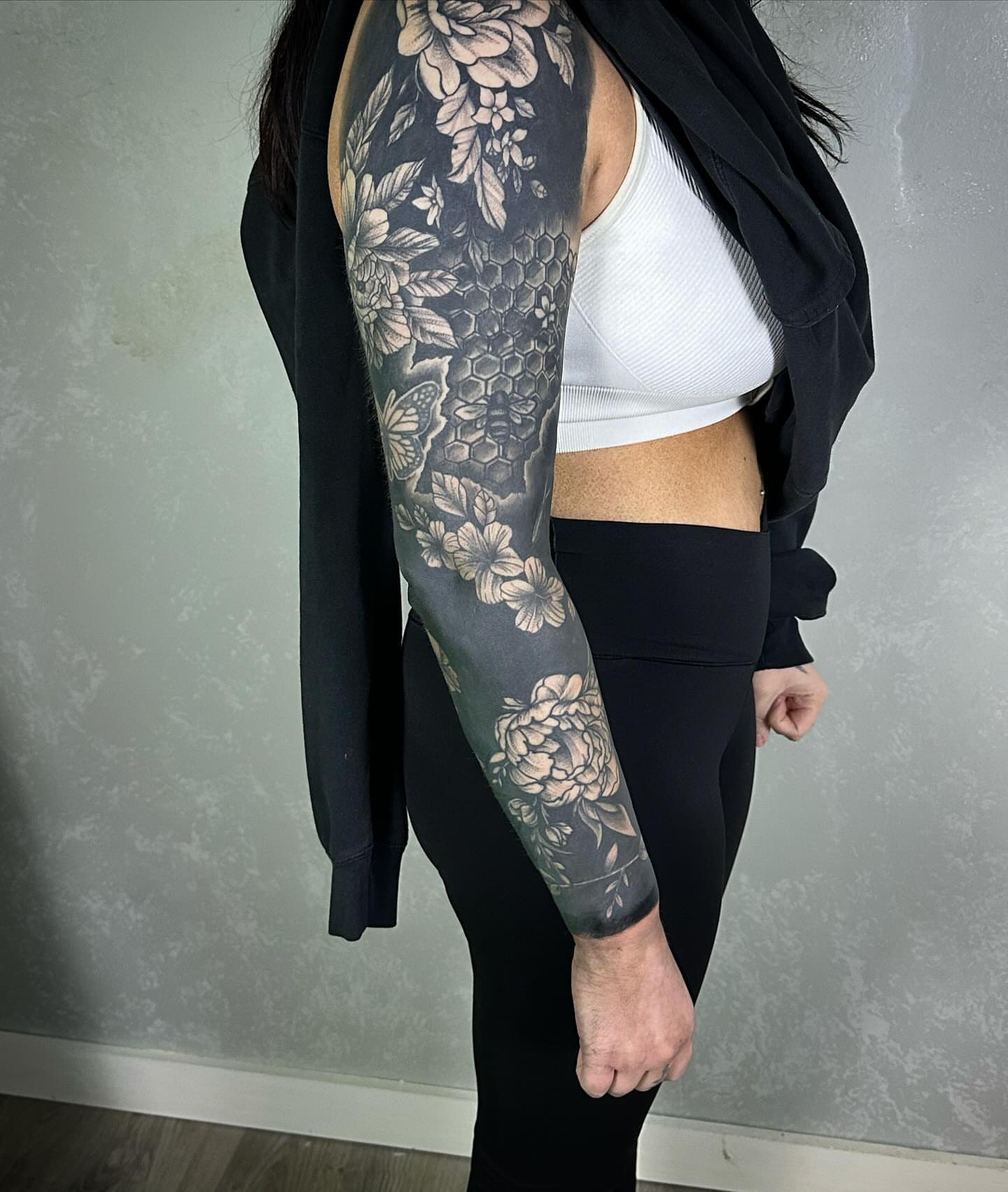 Floral and honeycomb geometric tattoo on the upper arm by Neil5one3